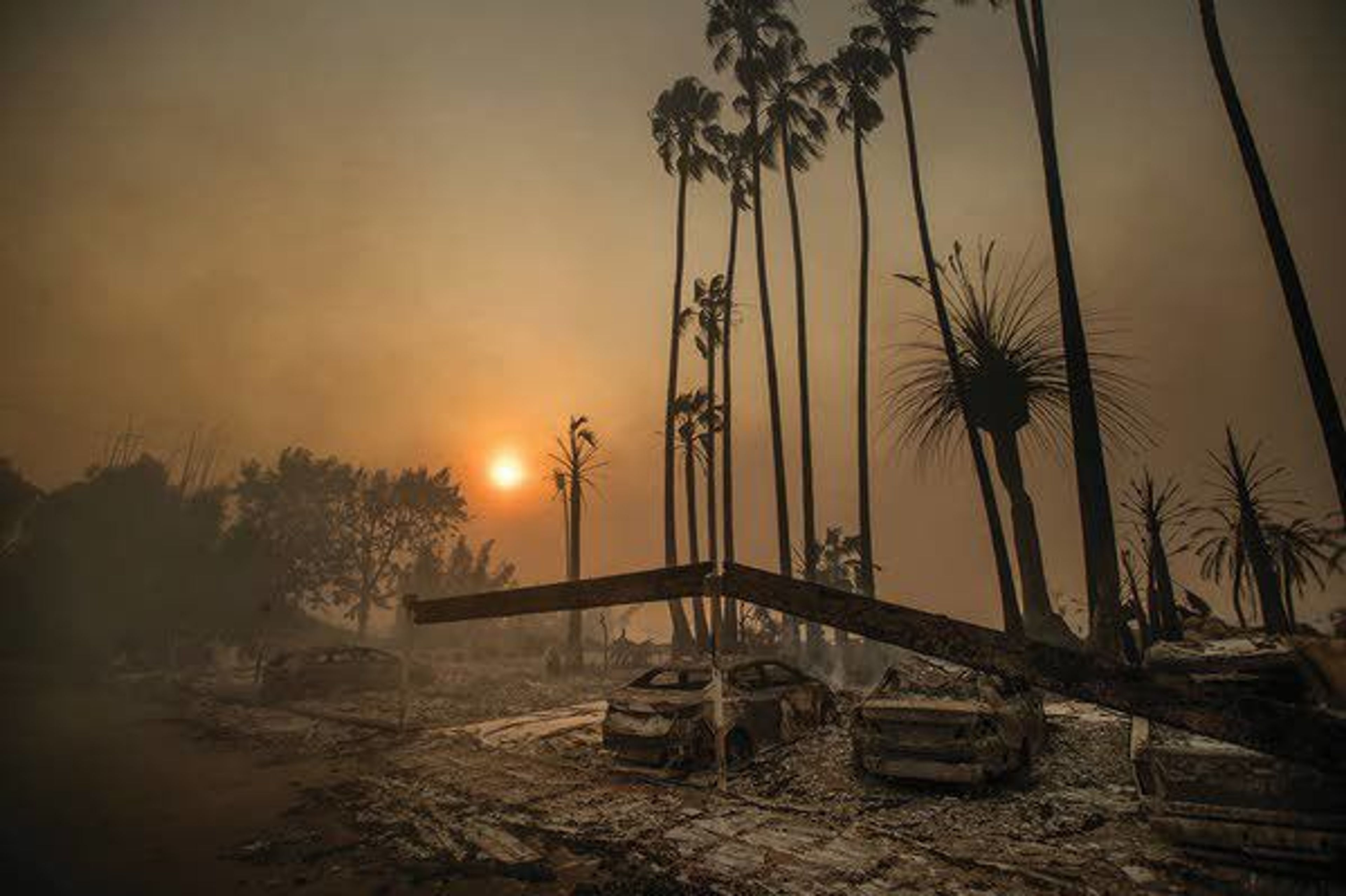 Smoke rises behind a destroyed apartment complex as a wildfire burns Dec. 5, 2017, in Ventura, Calif. In the 30 years since 1988, the number of acres burned in the U.S. by wildfires has doubled. (AP Photo/Noah Berger, File)