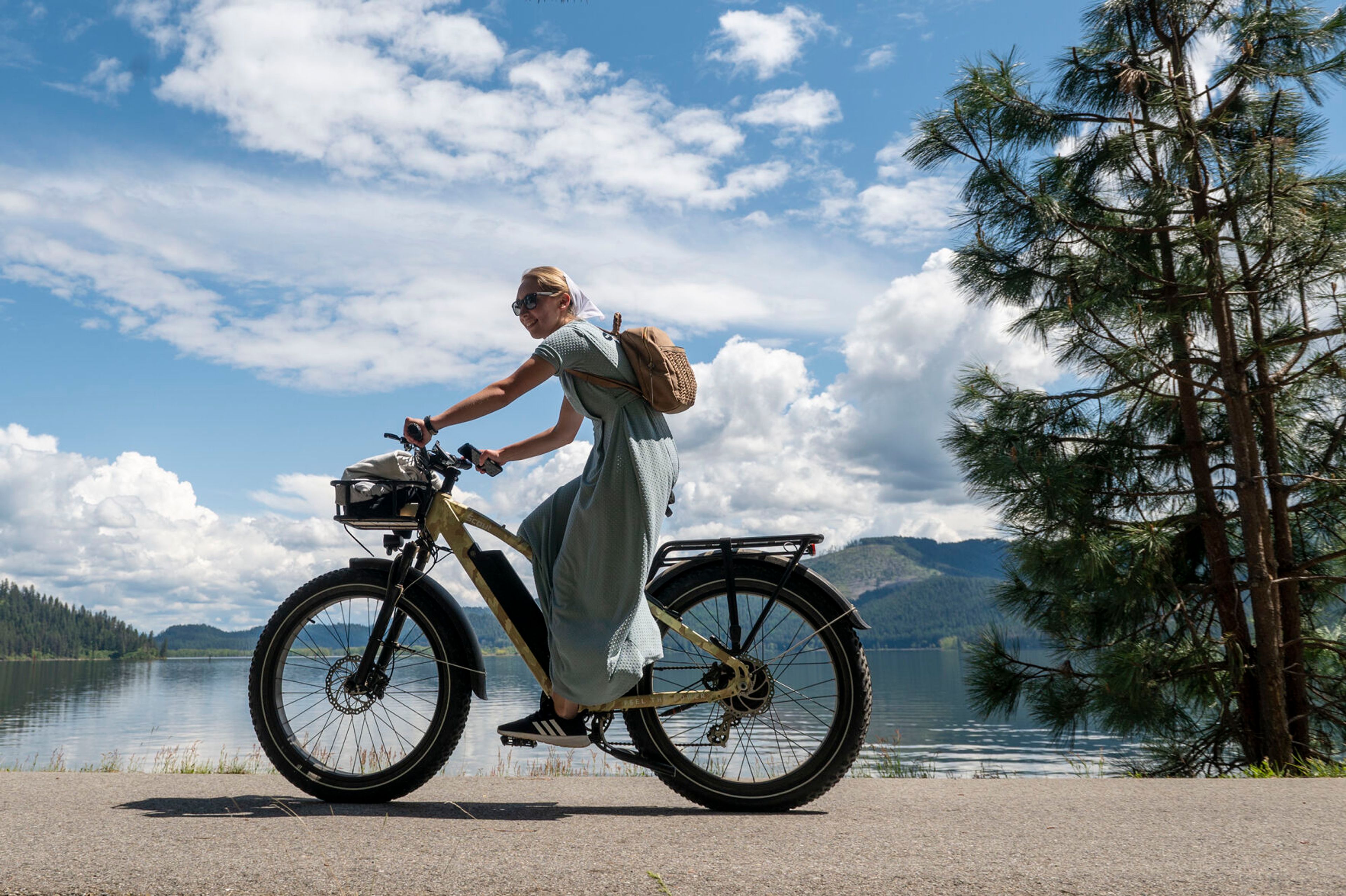 Chatcolet Lake is seen behind a cyclist riding along Trail of the Coeur d’Alene.