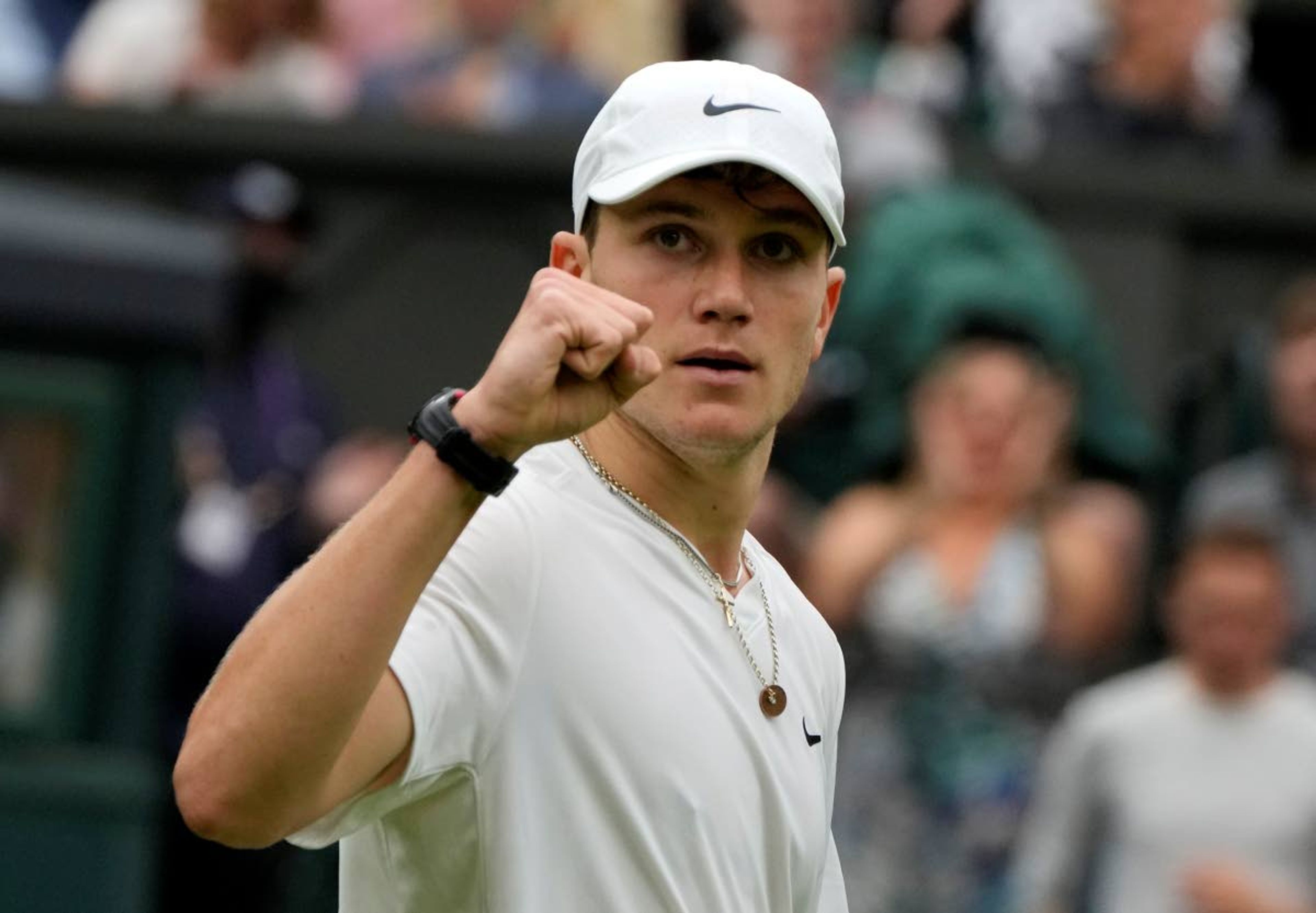 Britain's Jack Draper celebrates winning the first set against Serbia's Novak Djokovic during their first round men's singles match on day one of the Wimbledon Tennis Championships in London, Monday June 28, 2021. (AP Photo/Kirsty Wigglesworth)