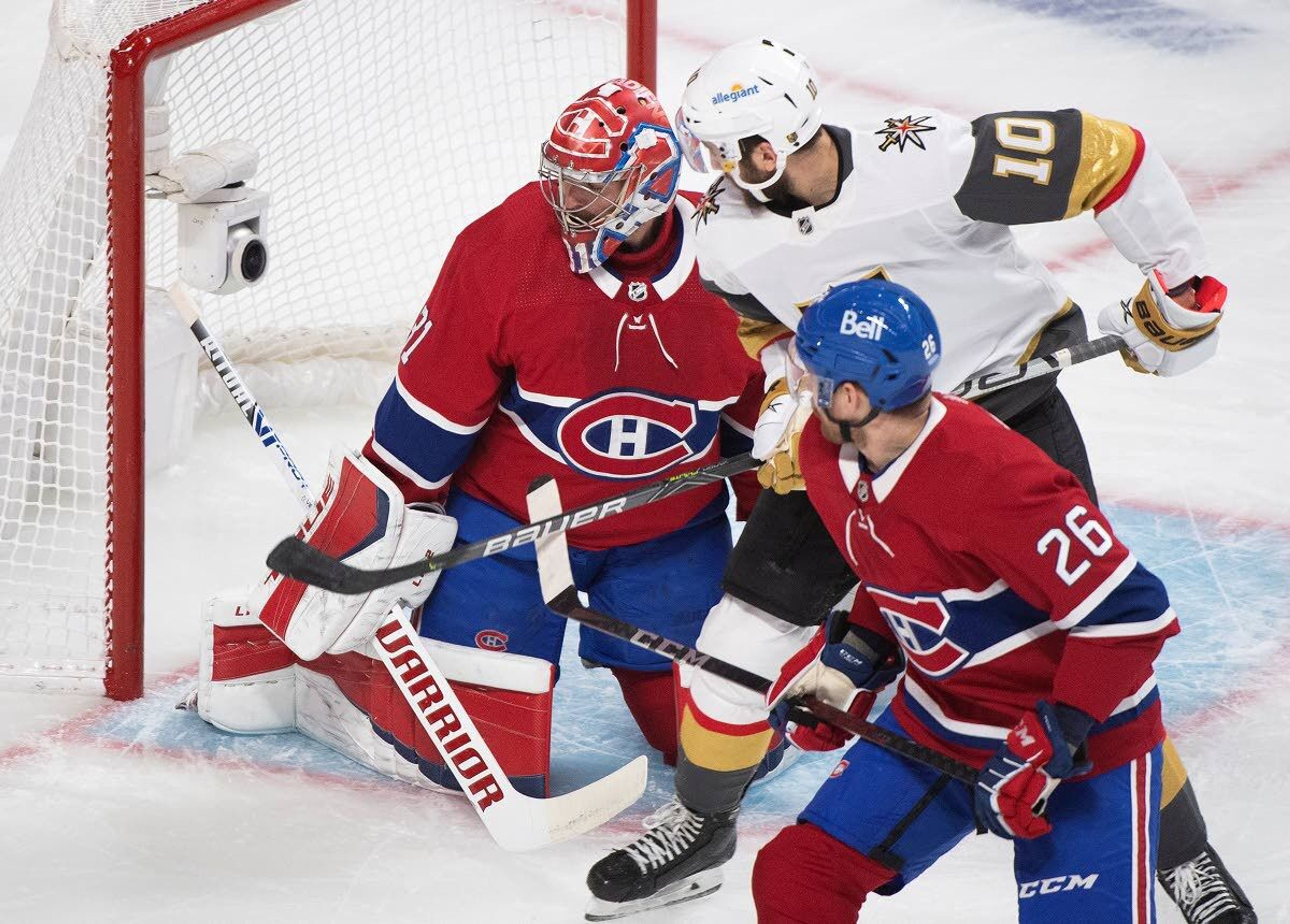 Vegas Golden Knights' Nicolas Roy (10) moves in aagainst Montreal Canadiens goaltender Carey Price as Canadiens' Jeff Petry defends during first-period Game 4 NHL Stanley Cup playoff hockey semifinal action in Montreal, Sunday, June 20, 2021.