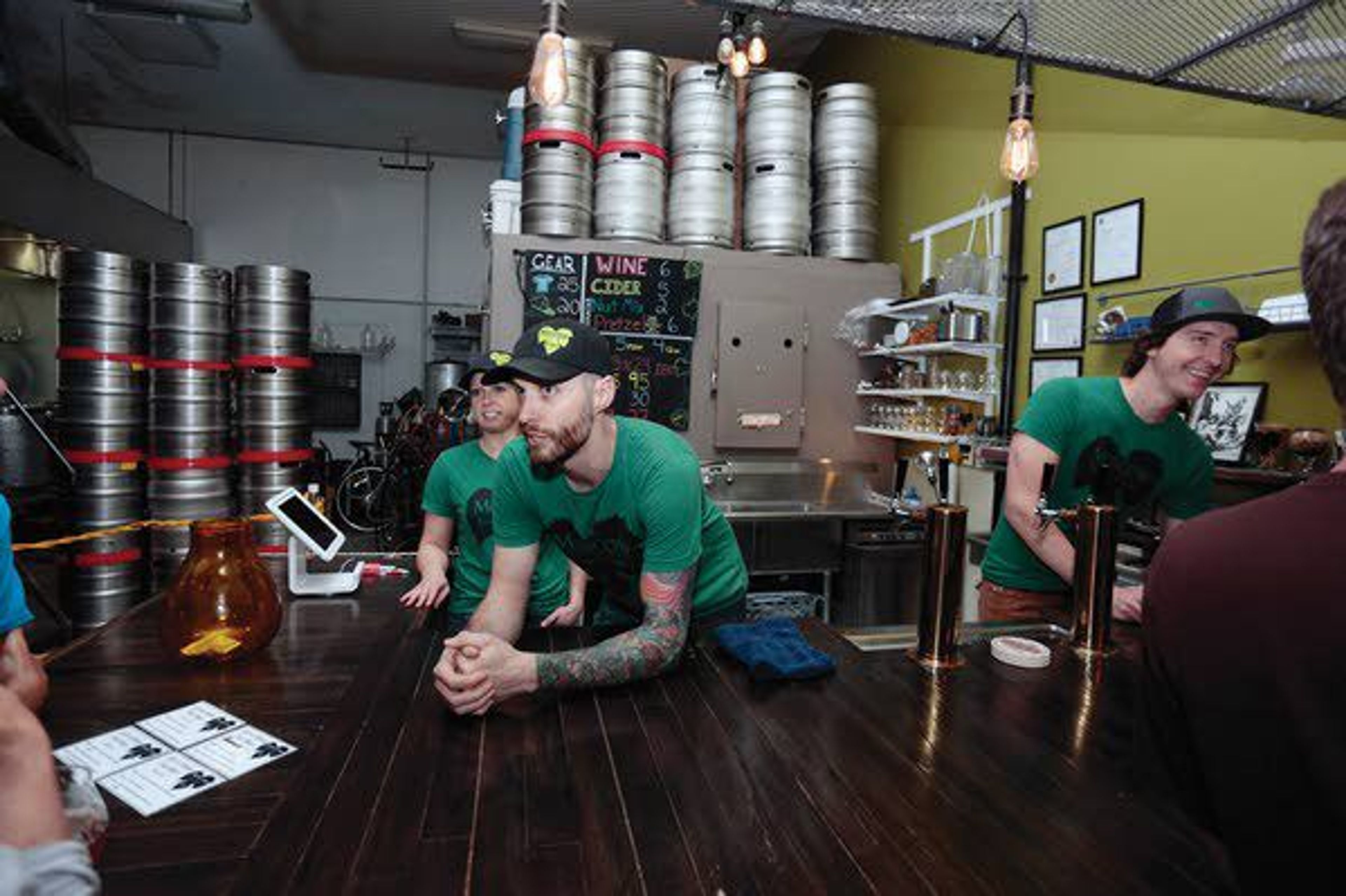 Leah Hart, Andy Severson and Aaron Hart tend to customers at Moscow Brewery on Friday. The trio reopened the establishment March 28.