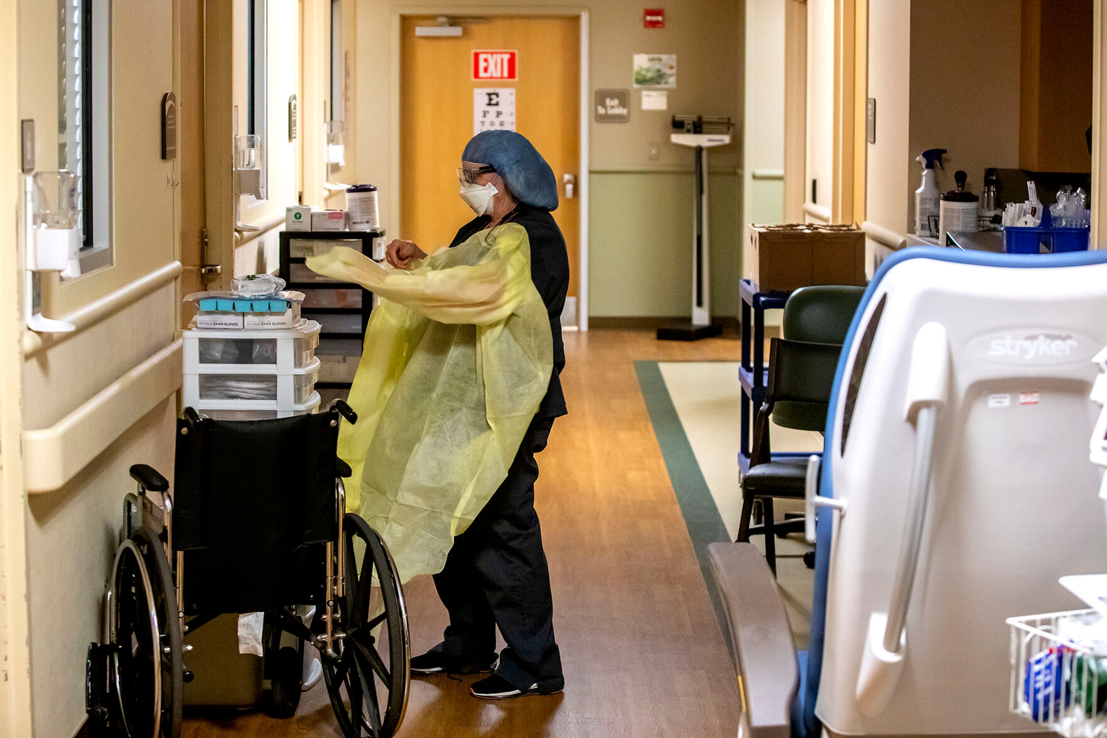 Janet Schroeder puts on protective gear for COVID precaution before heading into a patients room at the Pullman Regional Hospital emergency room Sept. 24.