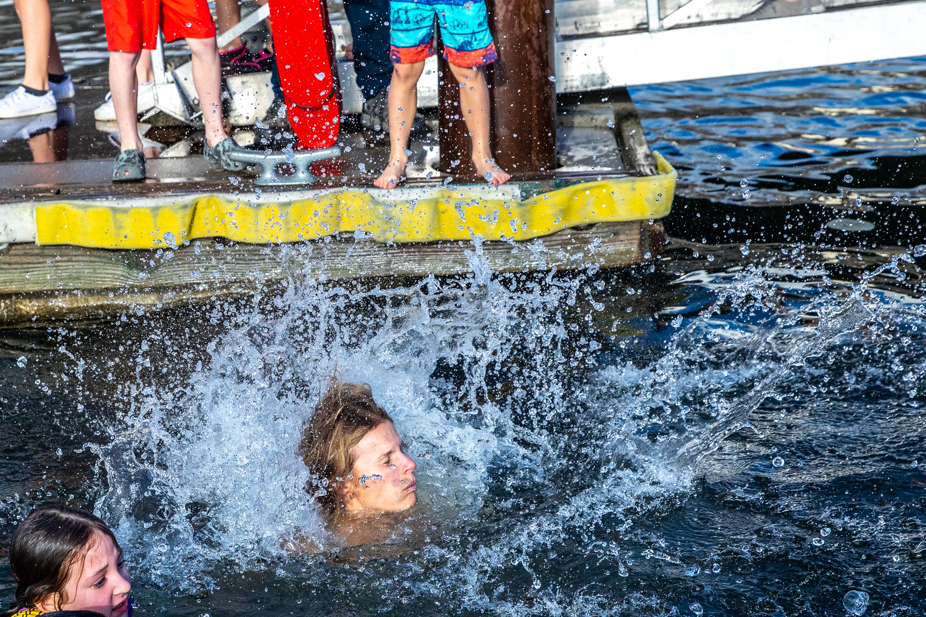 Water splashes up as people take the jump into the Snake River for the annual Polar Plunge Monday in Clarkston.