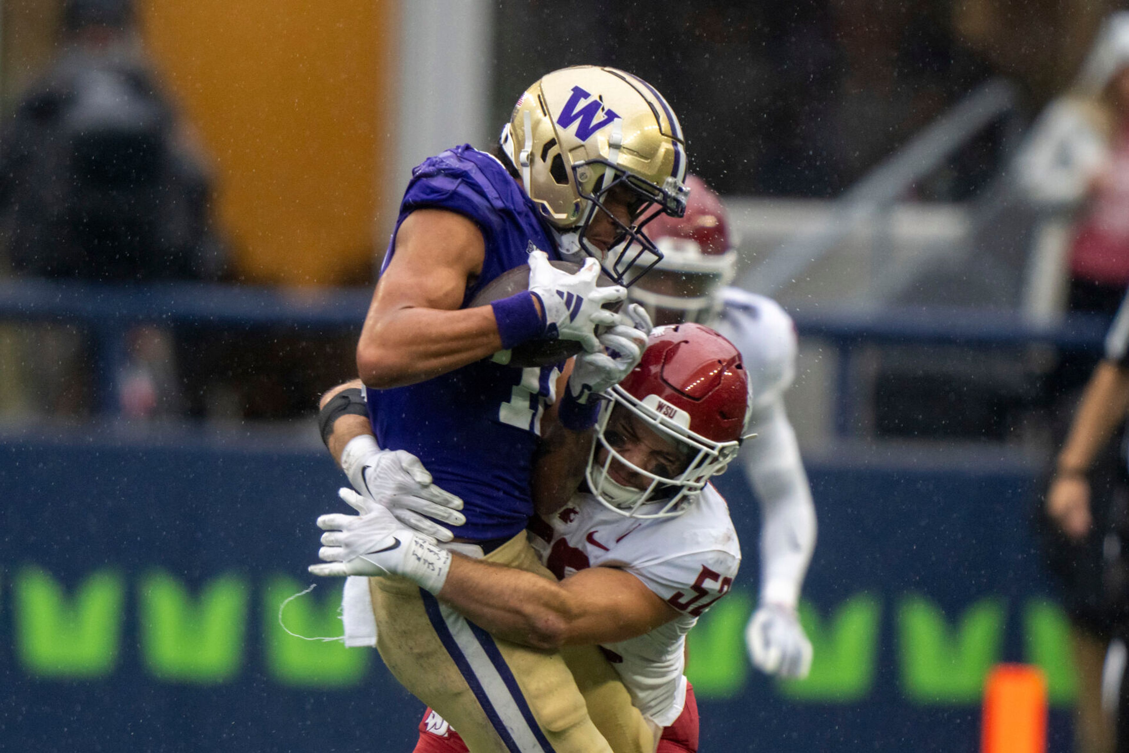 Washington wide receiver Leon Neal Jr., left, is tackleb y Washington State linebacker Kyle Thornton during the second half of an NCAA football game on Saturday, Sept. 14, 2024, in Seattle. Washington State won 24-19. (AP Photo/Stephen Brashear)