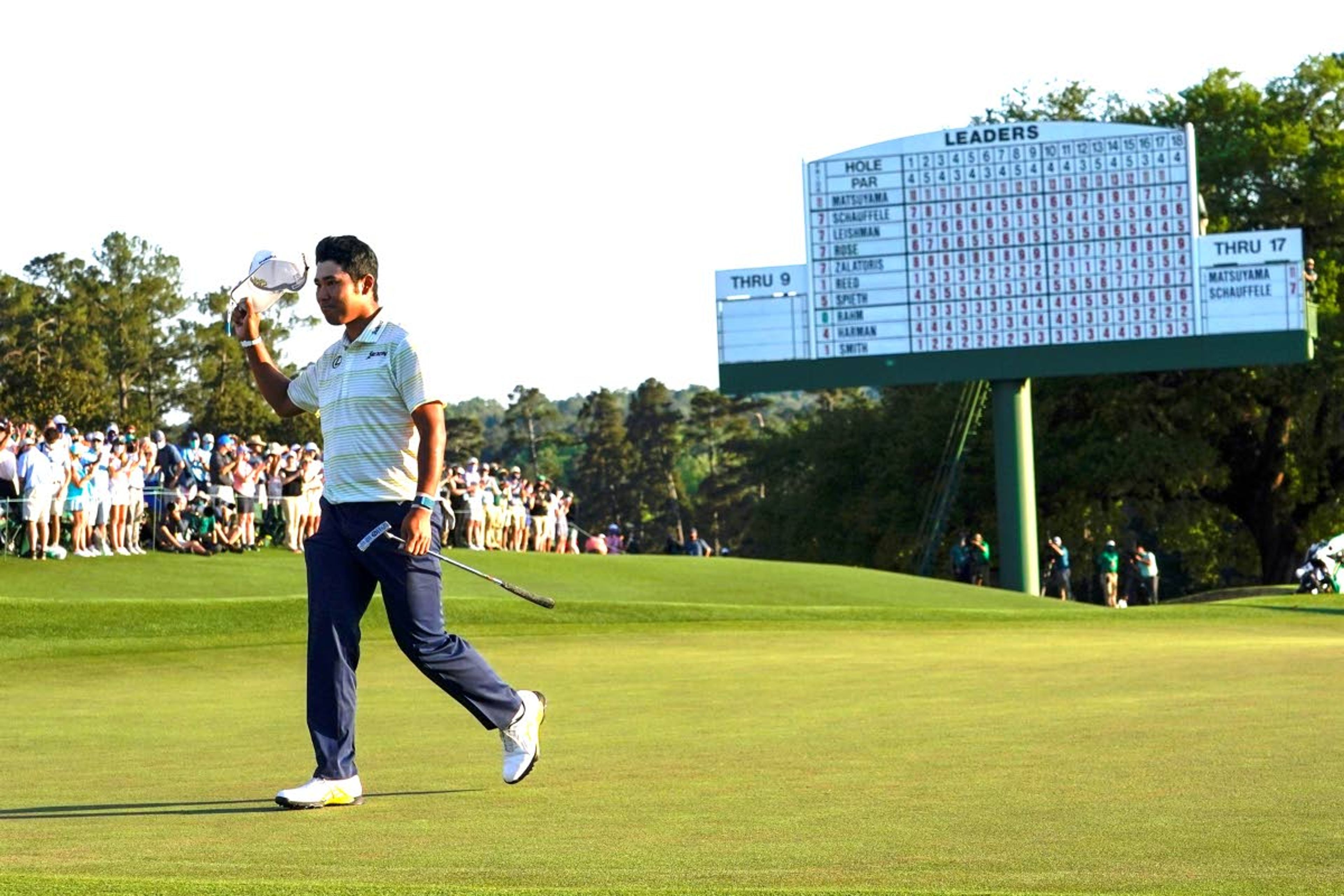 Hideki Matsuyama, of Japan, waves his cap after winning the Masters golf tournament Sunday in Augusta, Ga.