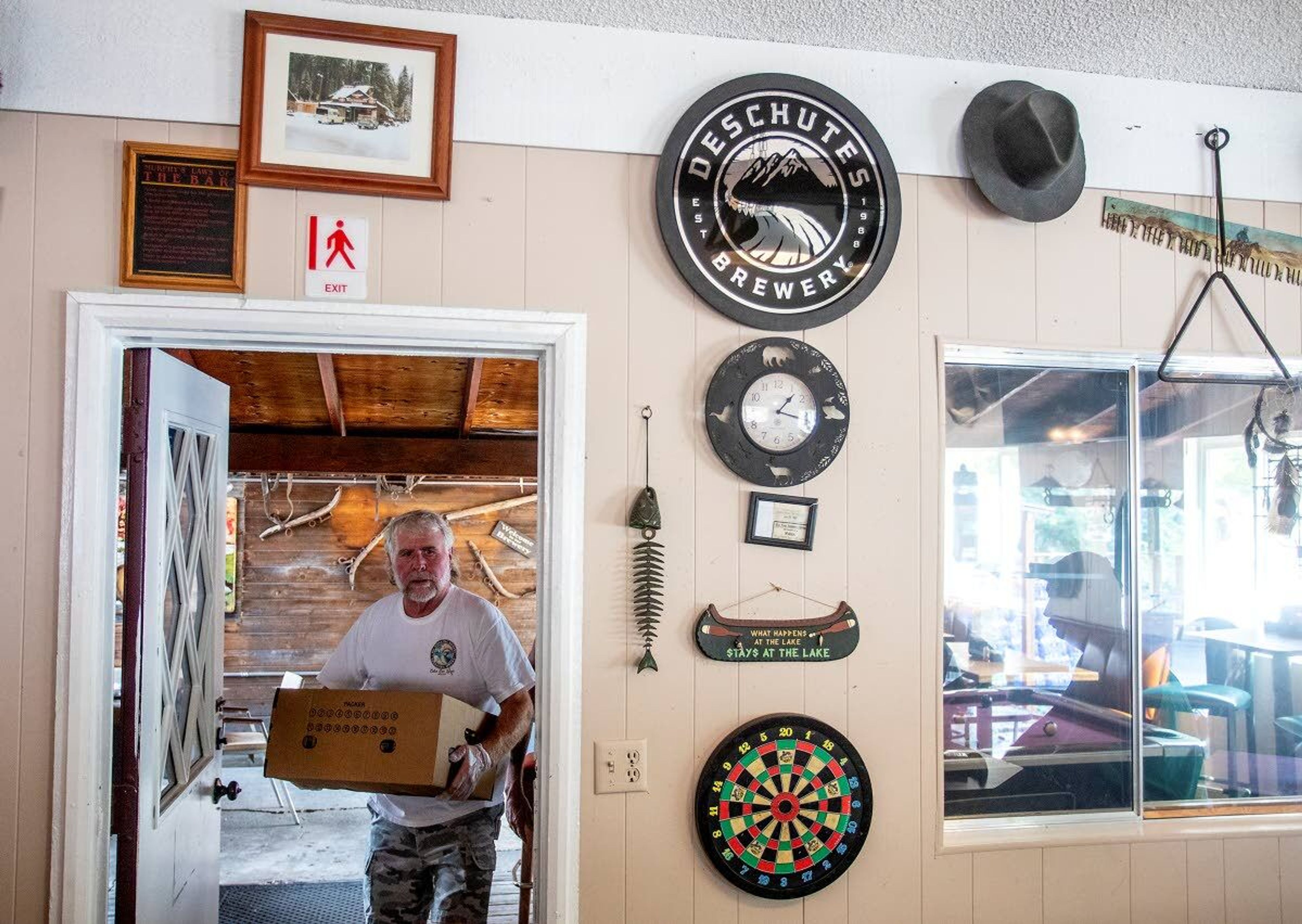 Volunteers bring food, water and other supplies into the Waha Bar and Grill on Saturday.