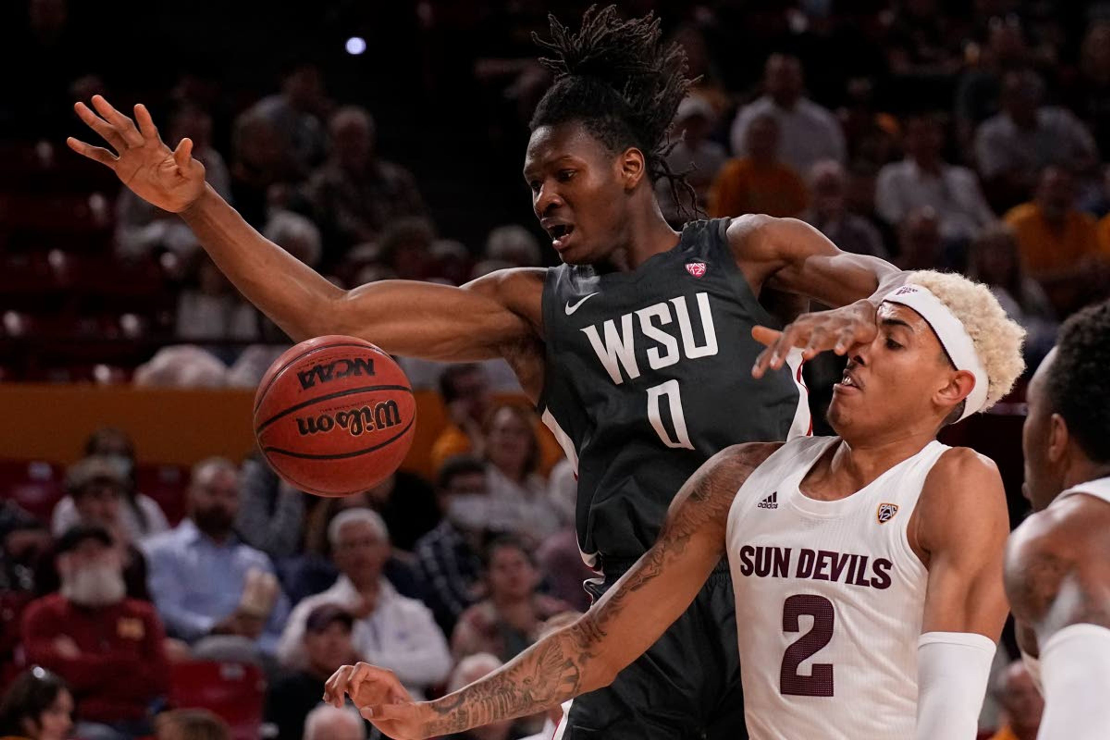 Washington State forward Efe Abogidi (0) and Arizona State forward Jalen Graham fight for the loose ball during the first half of an NCAA college basketball game, Wednesday, Dec. 1, 2021, in Tempe, Ariz. (AP Photo/Rick Scuteri)