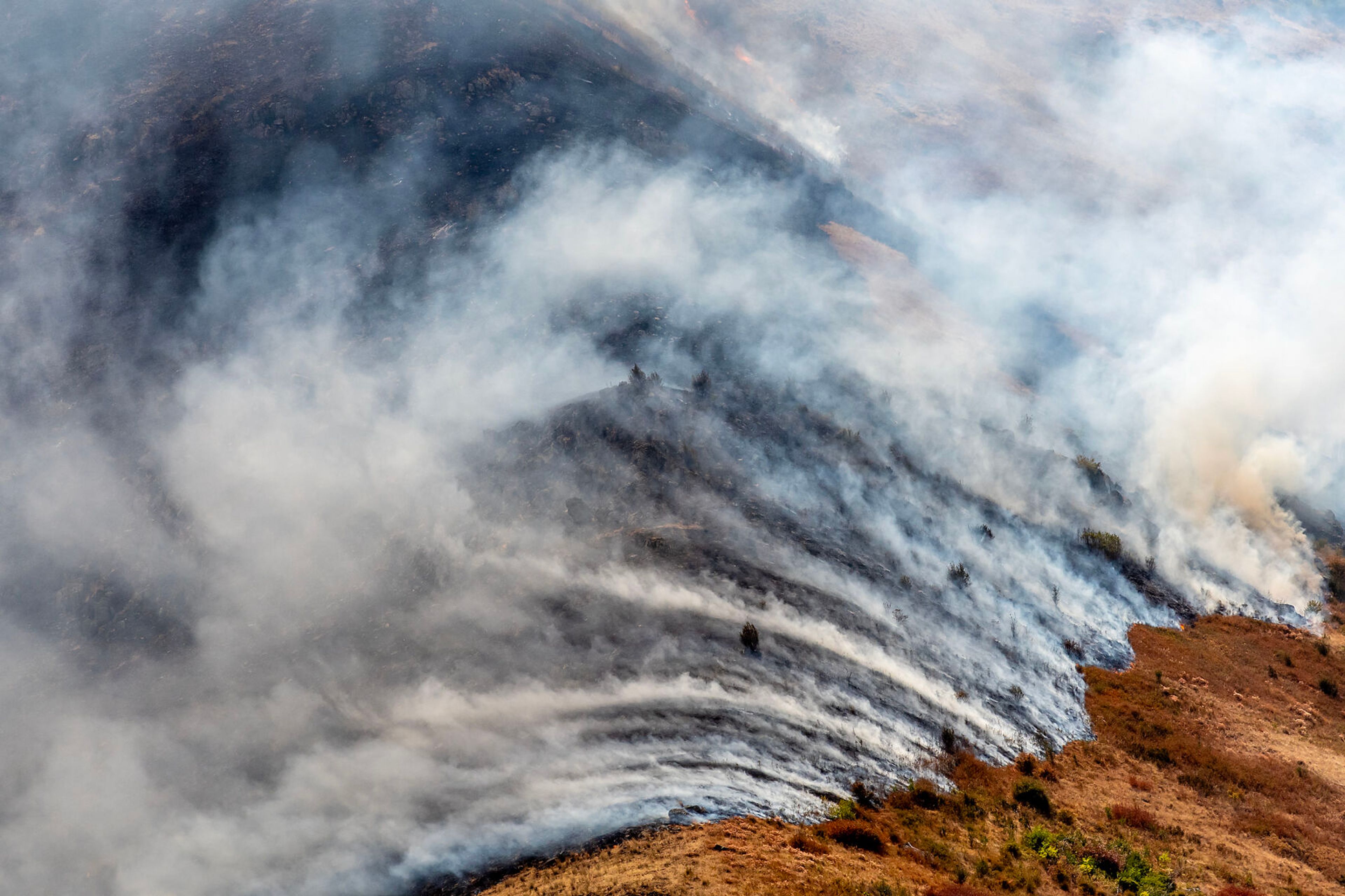 Smoke is blown across the hillsides at the Lower Granite Fire Tuesday off the Snake River.