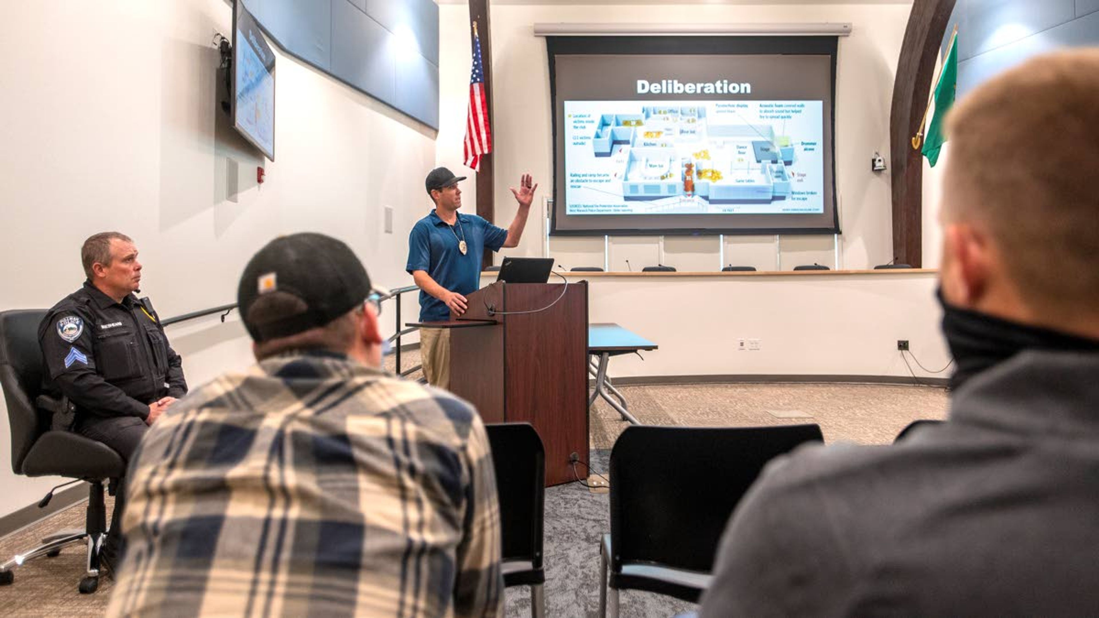 Sergeant Aaron Breshears, left, and detective Josh Bray, middle, of the Pullman Police Department give a presentation on active shooter training to city employees at Pullman City Hall on Wednesday afternoon.