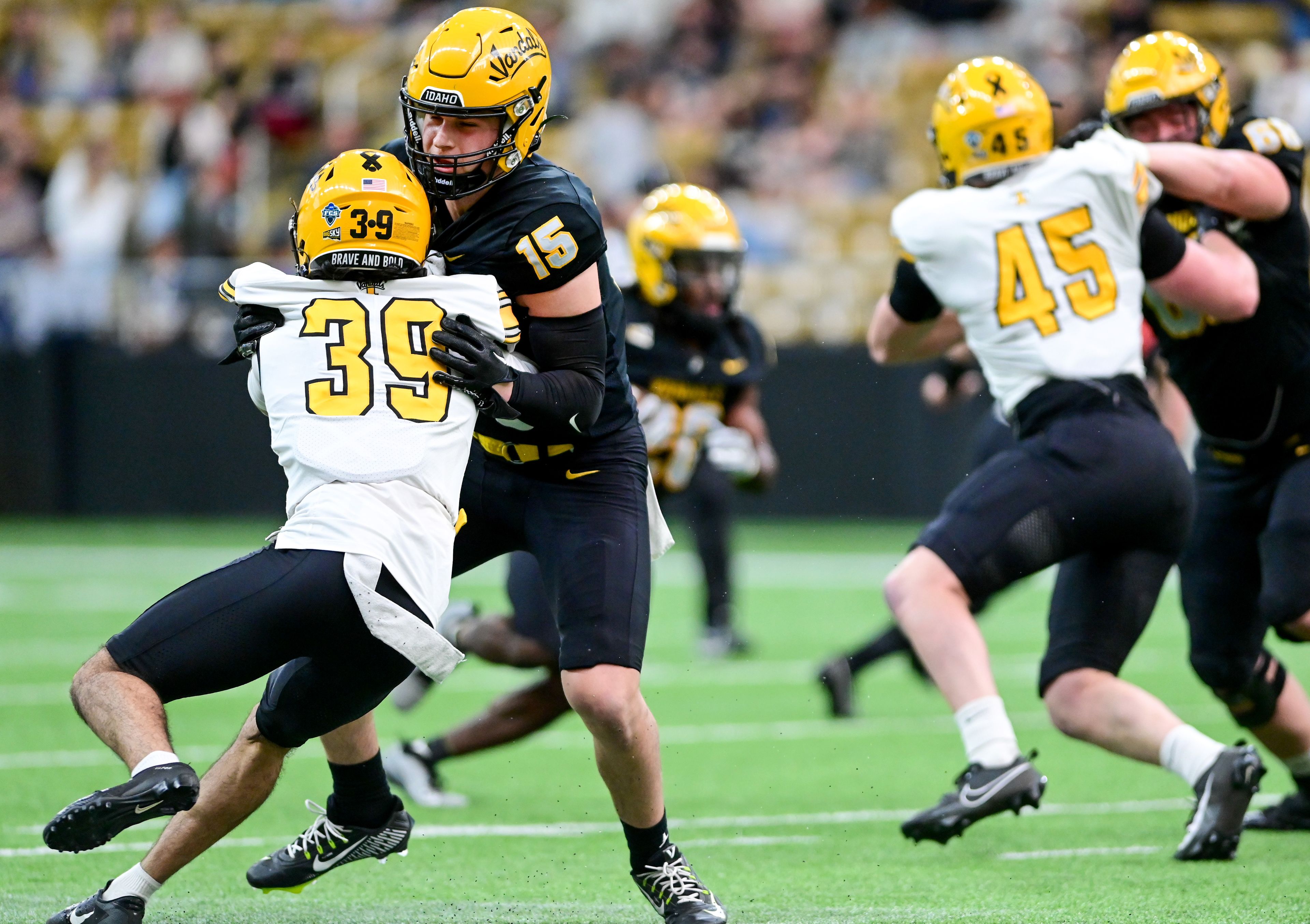 Vandals defensive back Jacob Skobis (39) and wide receiver Mark Hamper (15) collide during the annual spring game at the P1FCU Kibbie Dome in Moscow on Friday.