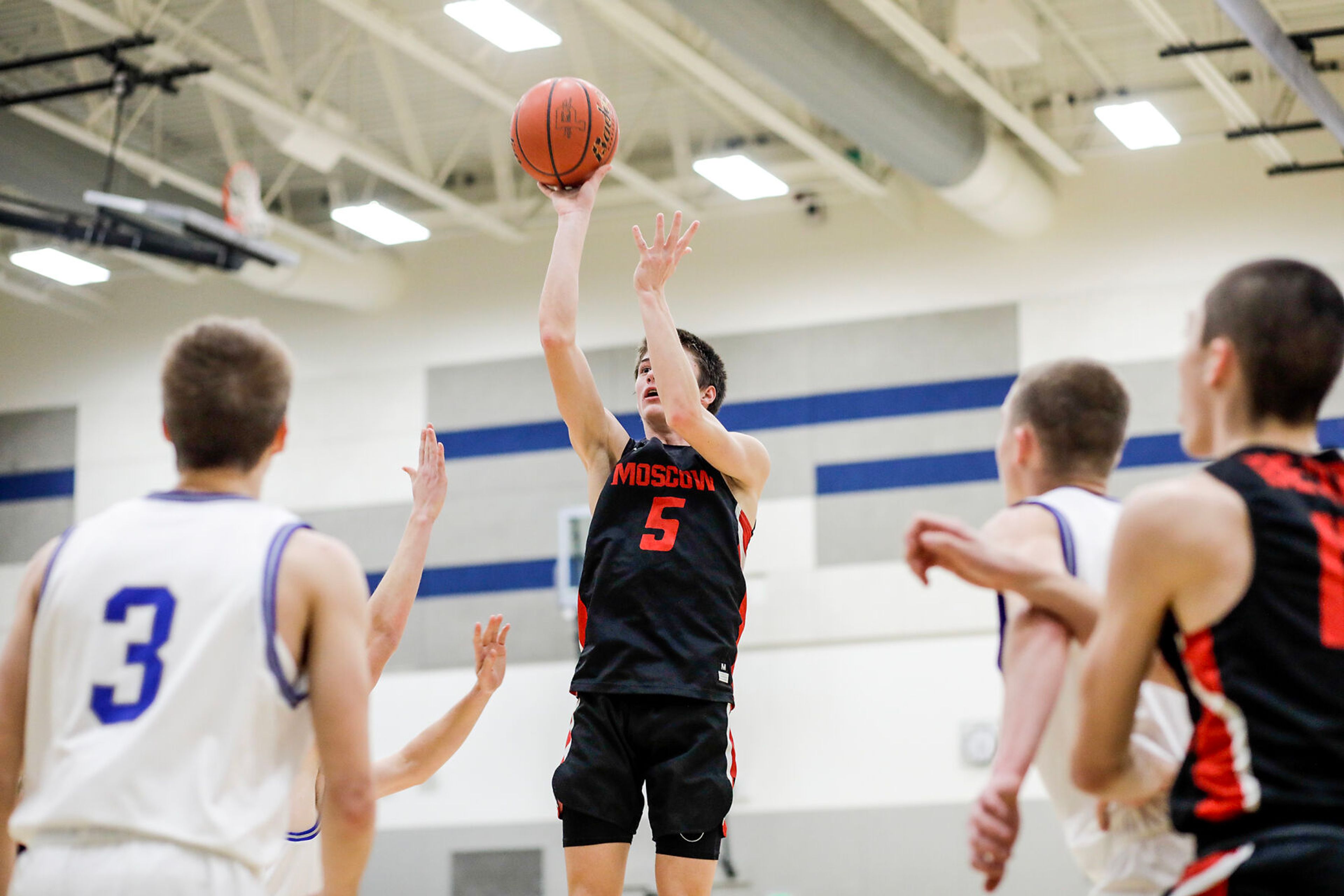 Moscow guard Traiden Cummings, center, shoots the ball during Saturday's nonleague boys basketball game.