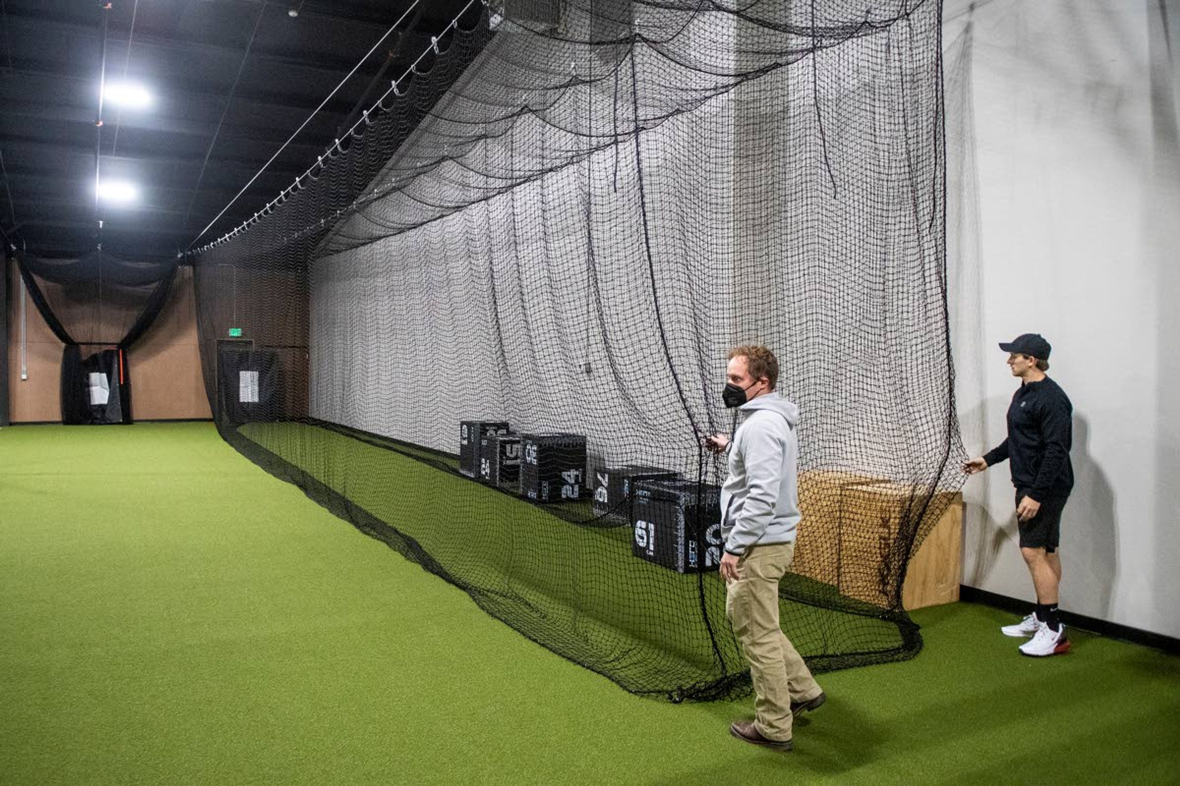 Zach Wilkinson/Daily NewsFacility director Matt Godfrey, left, and Seltenreich open one of the center’s batting cages.