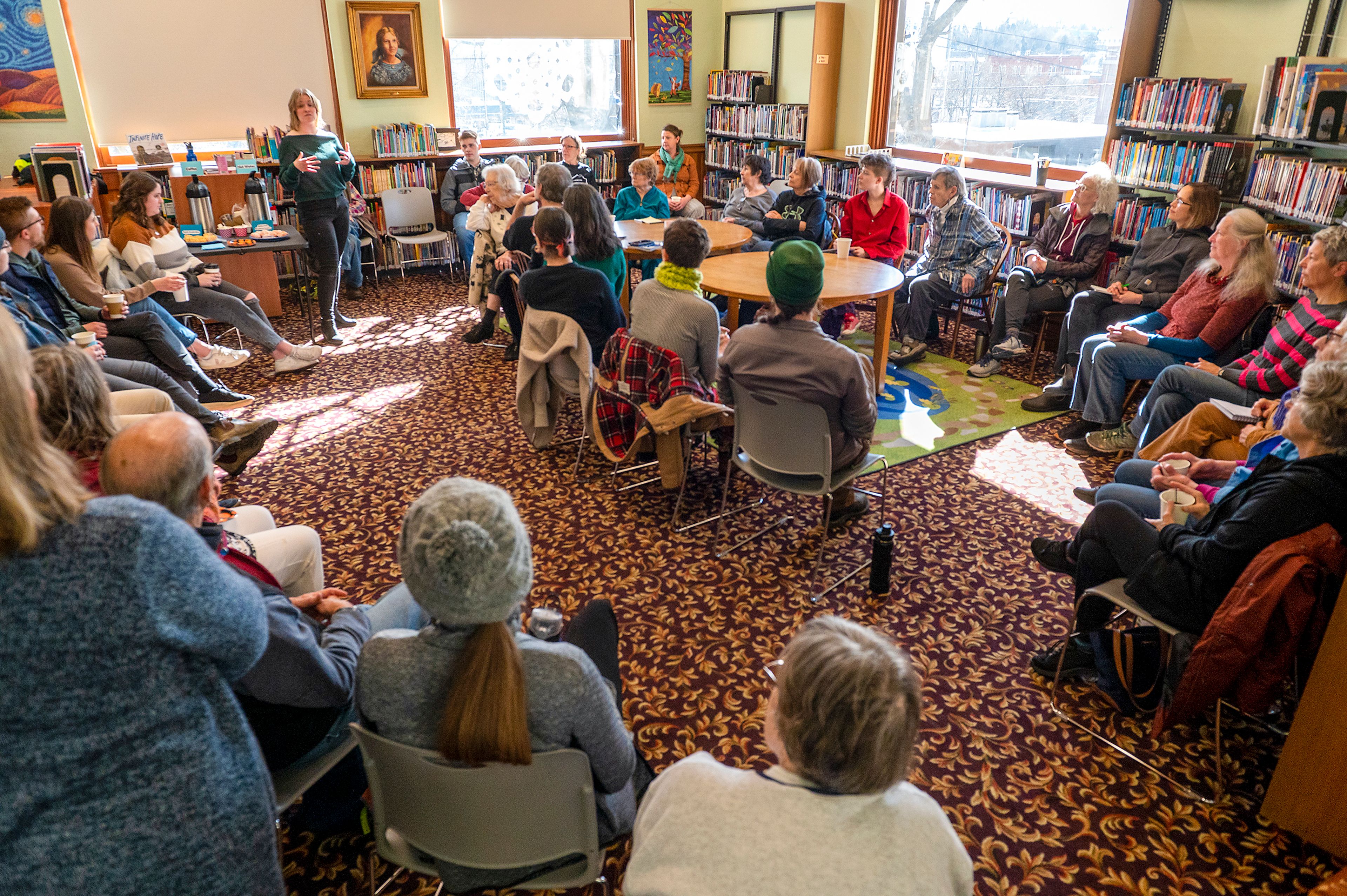 Amber Ziegler, standing, leads introductions during a Death Café, an informal discussion about death, Tuesday at the Moscow Public Library. “I’m just really grateful that so many people came. It’s an awesome starting point to keep moving forward,” Ziegler said.