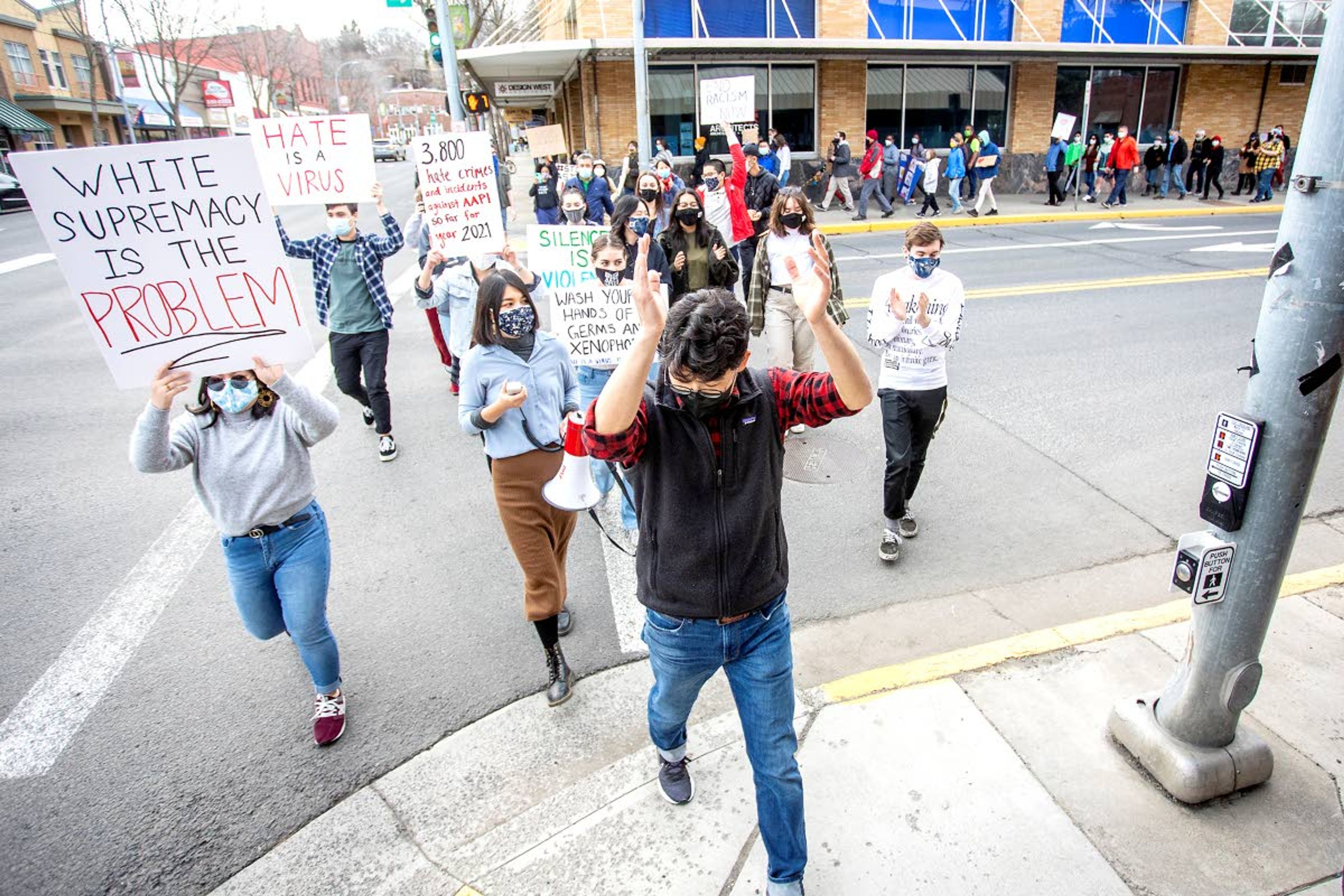 Yong Chae Rhee claps his hands as he leads the “Stop AAPI Hate on the Palouse” rally across the street. Rhee, a professor at Washington State University, was one of the rally’s organizers.