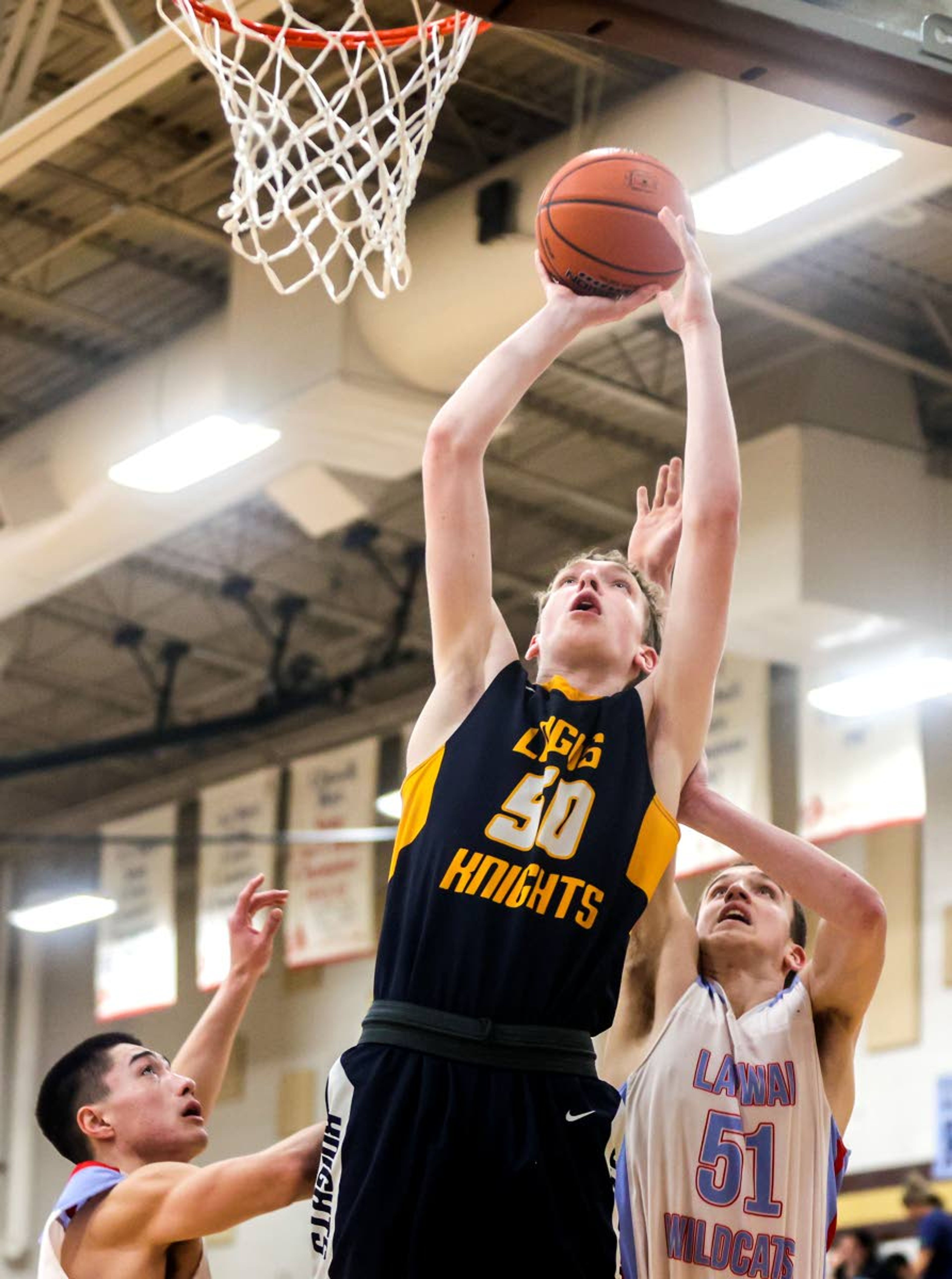 Lapwai forward Chris Bohnee prepares to shoot the ball as Lapwai forward Kase Wynott (51) defends during round two of the Idaho High School boys state basketball tournament at Vallivue High School on Friday.