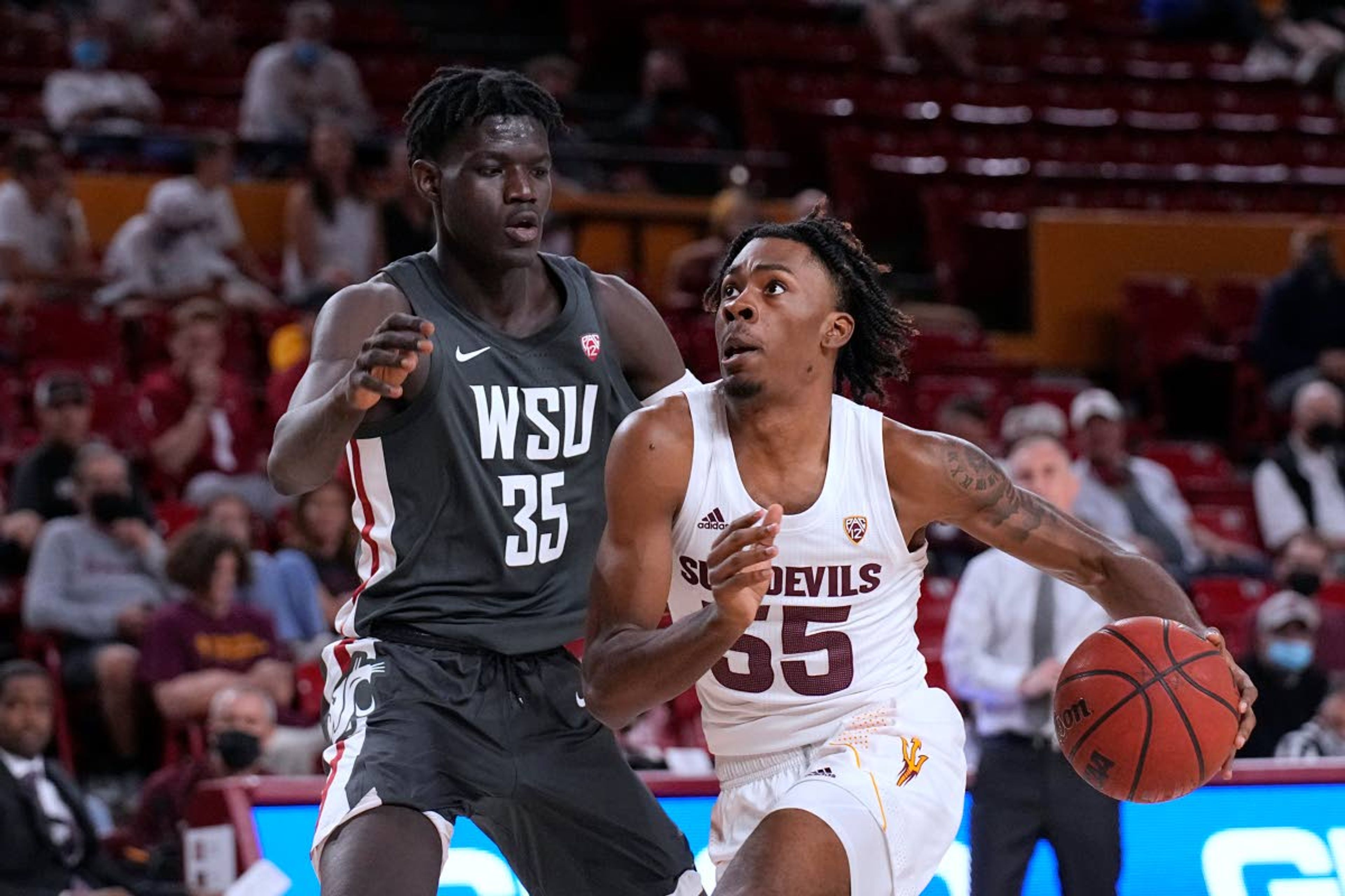 Arizona State forward Jamiya Neal drives on Washington State forward Mouhamed Gueye (35) during the second half of an NCAA college basketball game Wednesday, Dec. 1, 2021, in Tempe, Ariz. Washington State won 51-29. (AP Photo/Rick Scuteri)