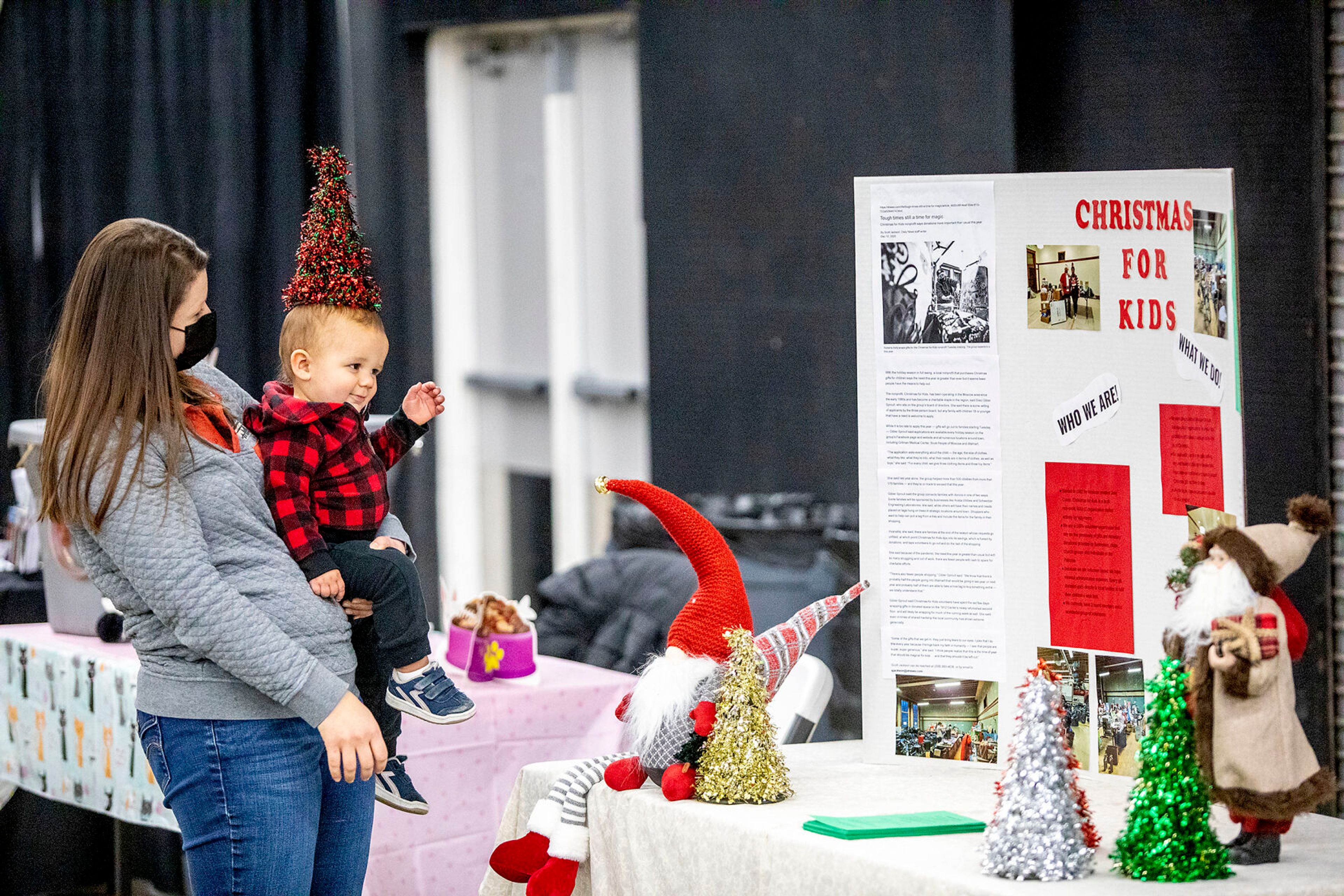 Dulce Kersting-Lark places a decoration atop her son Booker Kersting-Lark’s, 16 months, head at the Alternative Giving Market in Moscow on Saturday.