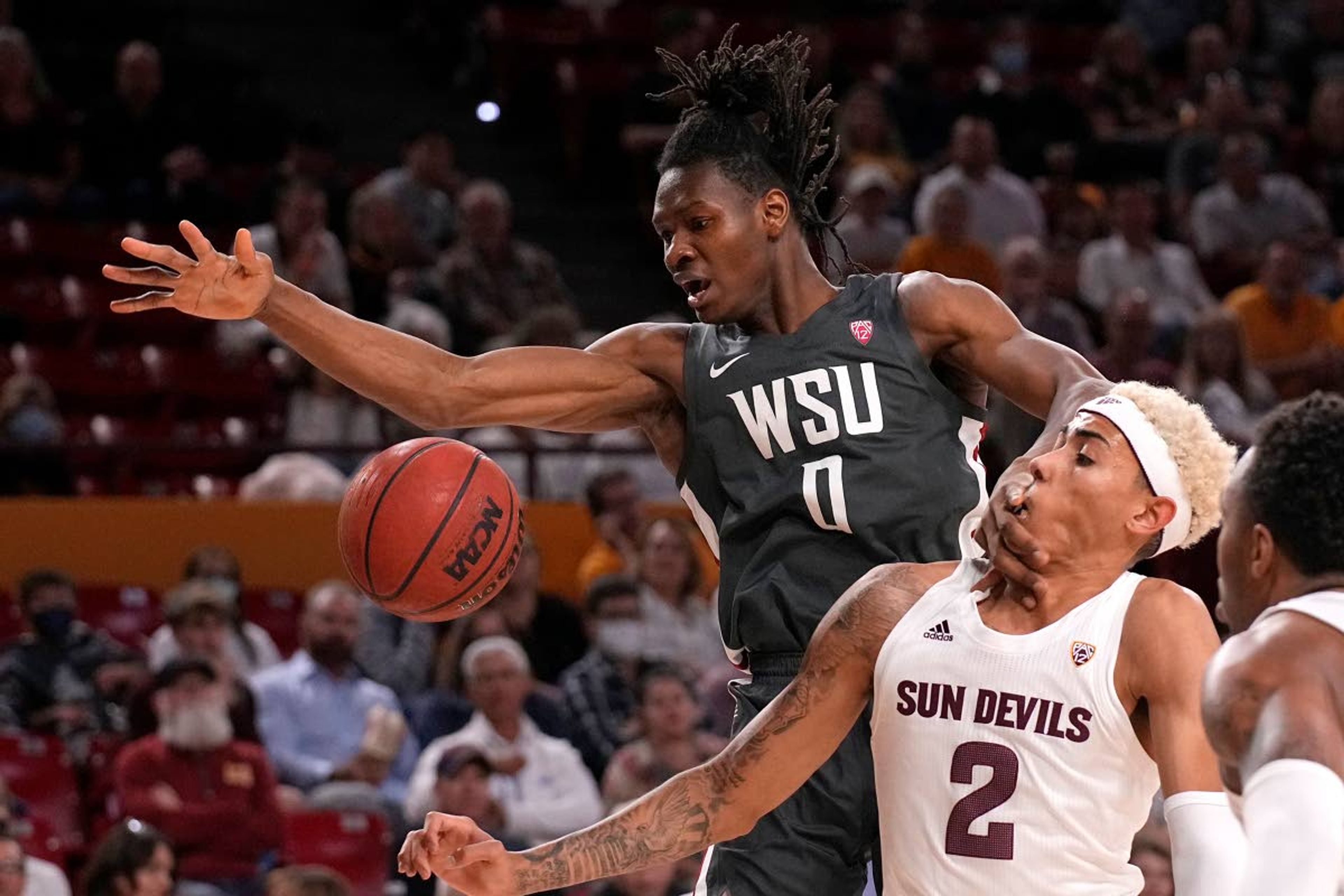 Washington State forward Efe Abogidi (0) and Arizona State forward Jalen Graham vie for the ball during the first half of an NCAA college basketball game Wednesday, Dec. 1, 2021, in Tempe, Ariz. (AP Photo/Rick Scuteri)