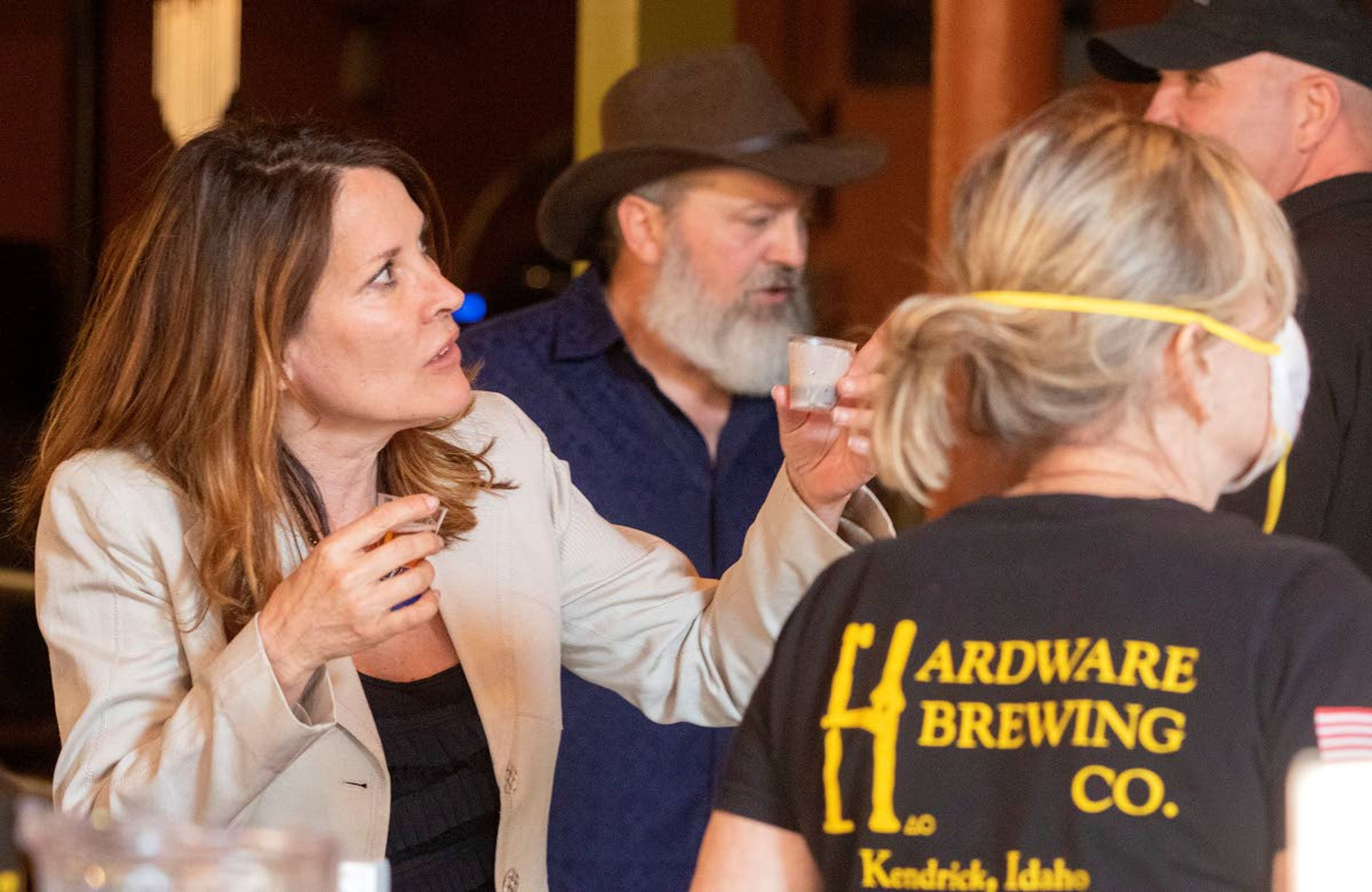 Idaho Lt. Gov. Janice McGeachin, left, talks with an employee on Friday at the Hardware Brewing Co. The business reopened to sit-down customers on Friday even though Gov. Brad Little's order still restricts restaurants to curbside and delivery sales.