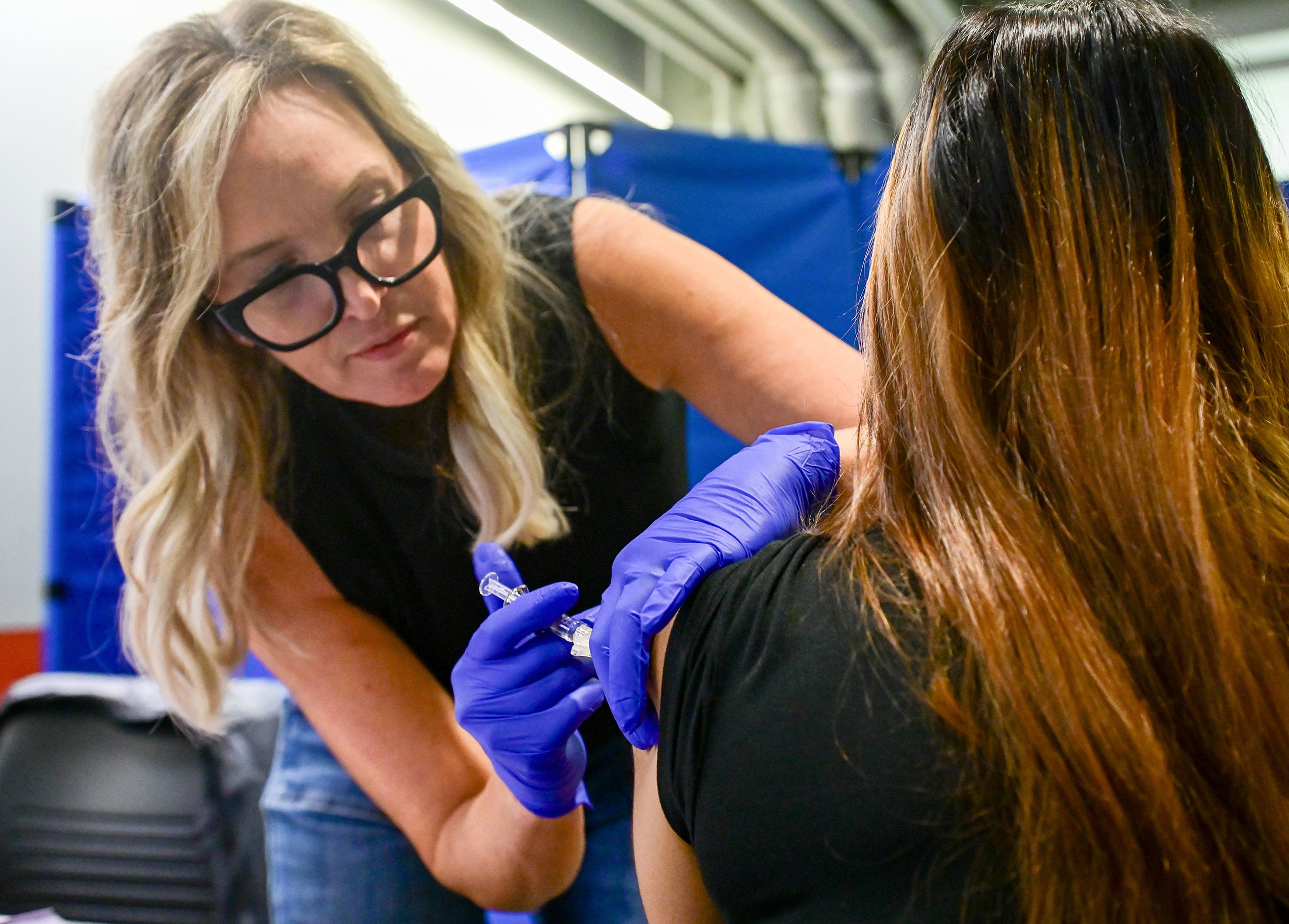 Chris Boyd, manager of Nursing Services at Cougar Health Services, gives flu vaccines to Washington State University students at the first Flu Shot Friday clinic on campus Friday in Pullman. The clinic for students takes place each Friday through November 1. Area health officials recommend residents get vaccinated for the flue and COVID-19 early in the fall for the best chance of avoiding sickness.