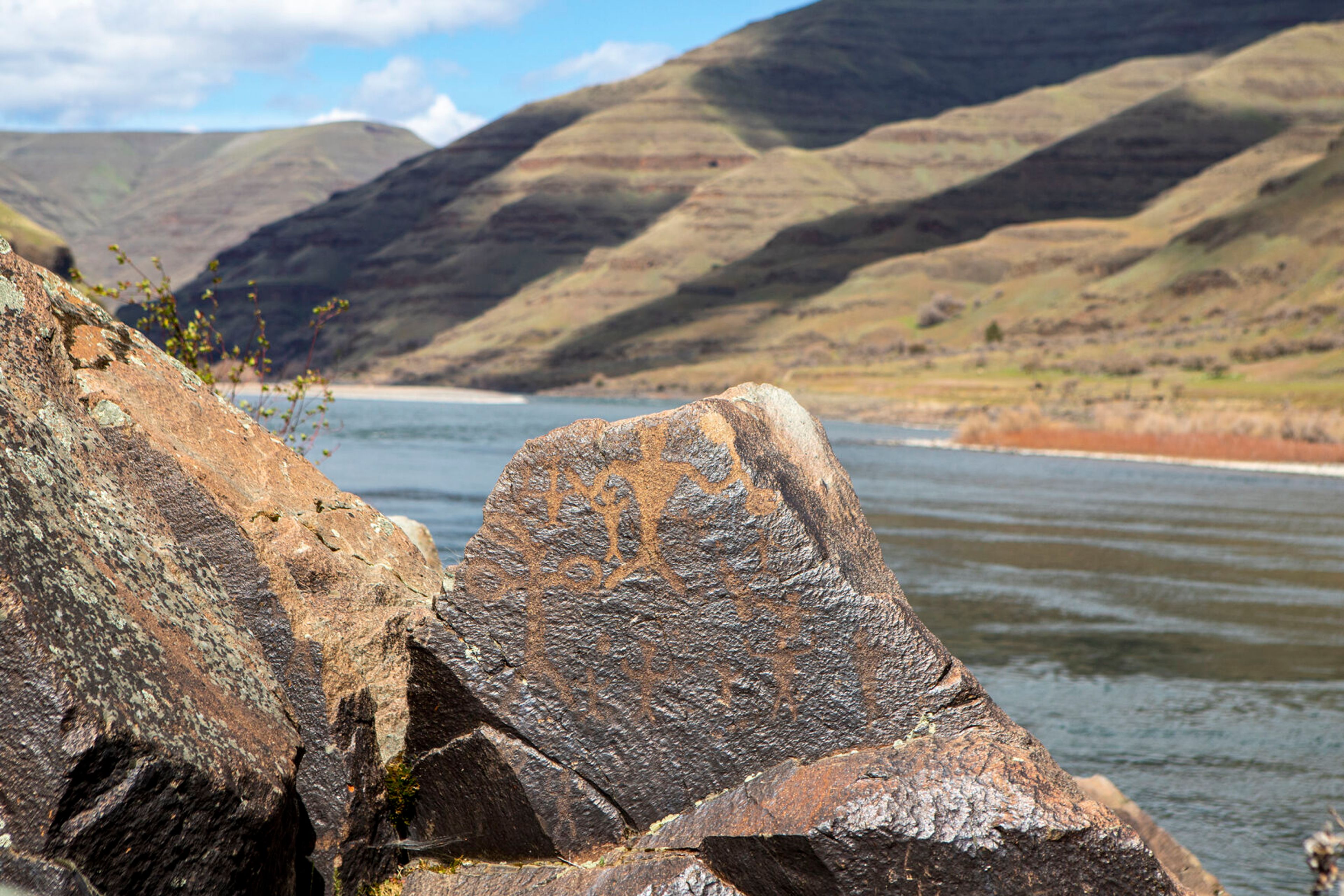 A large petroglyph prominently stands out against a backdrop of the Snake River at Buffalo Eddy, 18 miles south of Asotin.