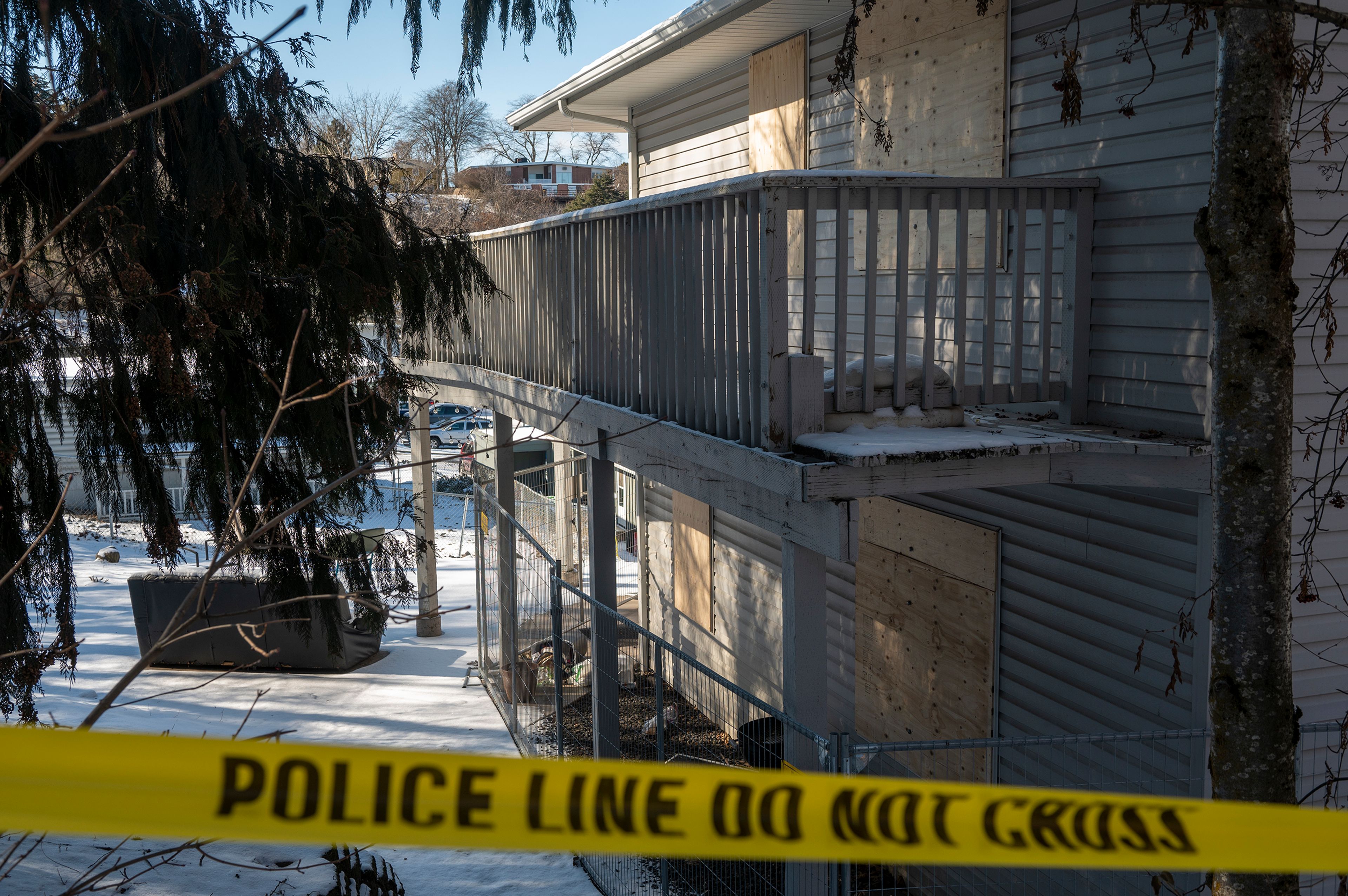 Caution tape and a fence surround the boarded up house on Moscow’s King Road where four University of Idaho students were stabbed to death in November.