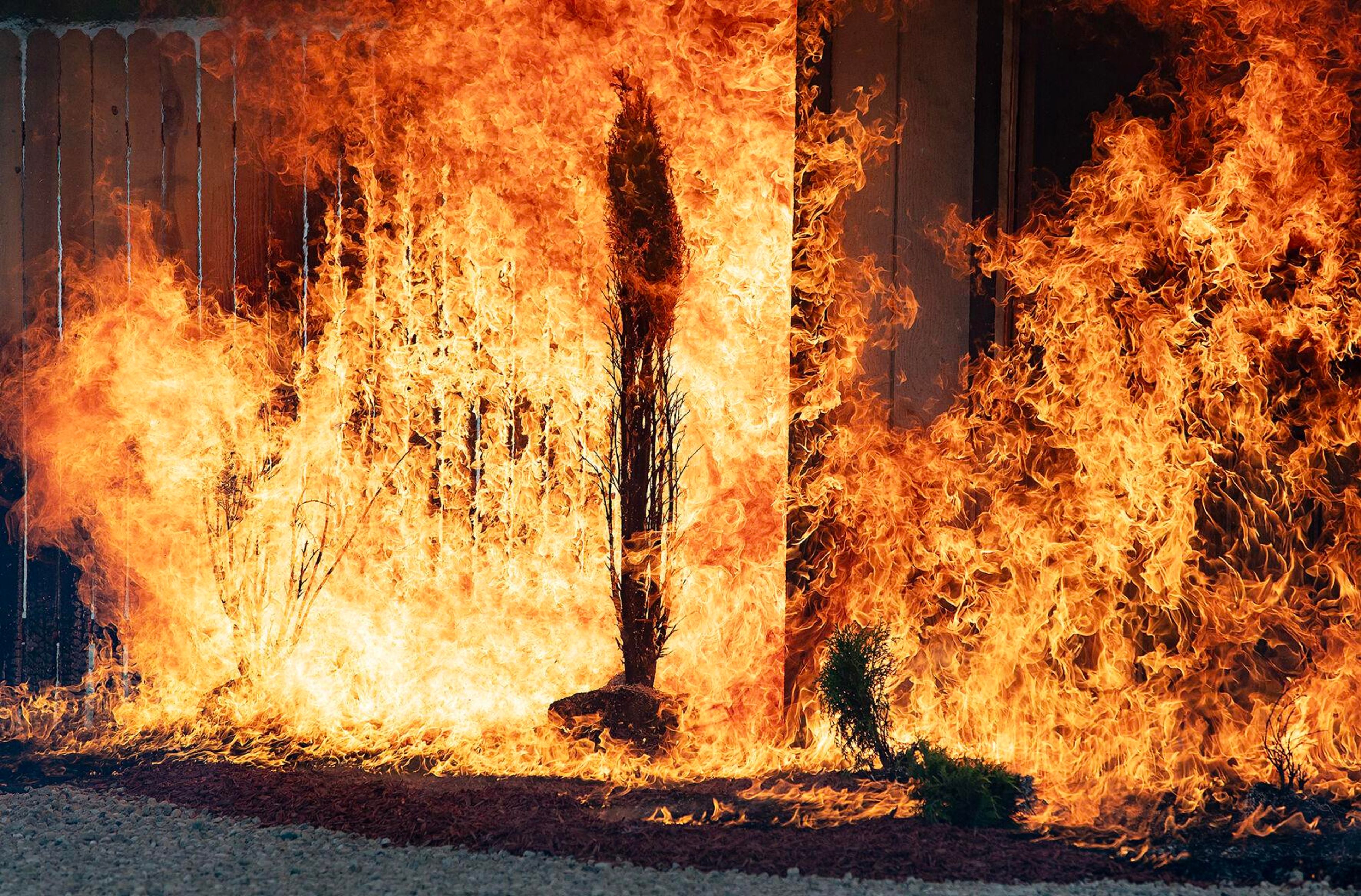 A small building is consumed by fire during a demonstration Monday at the National Interagency Fire Center in Boise.