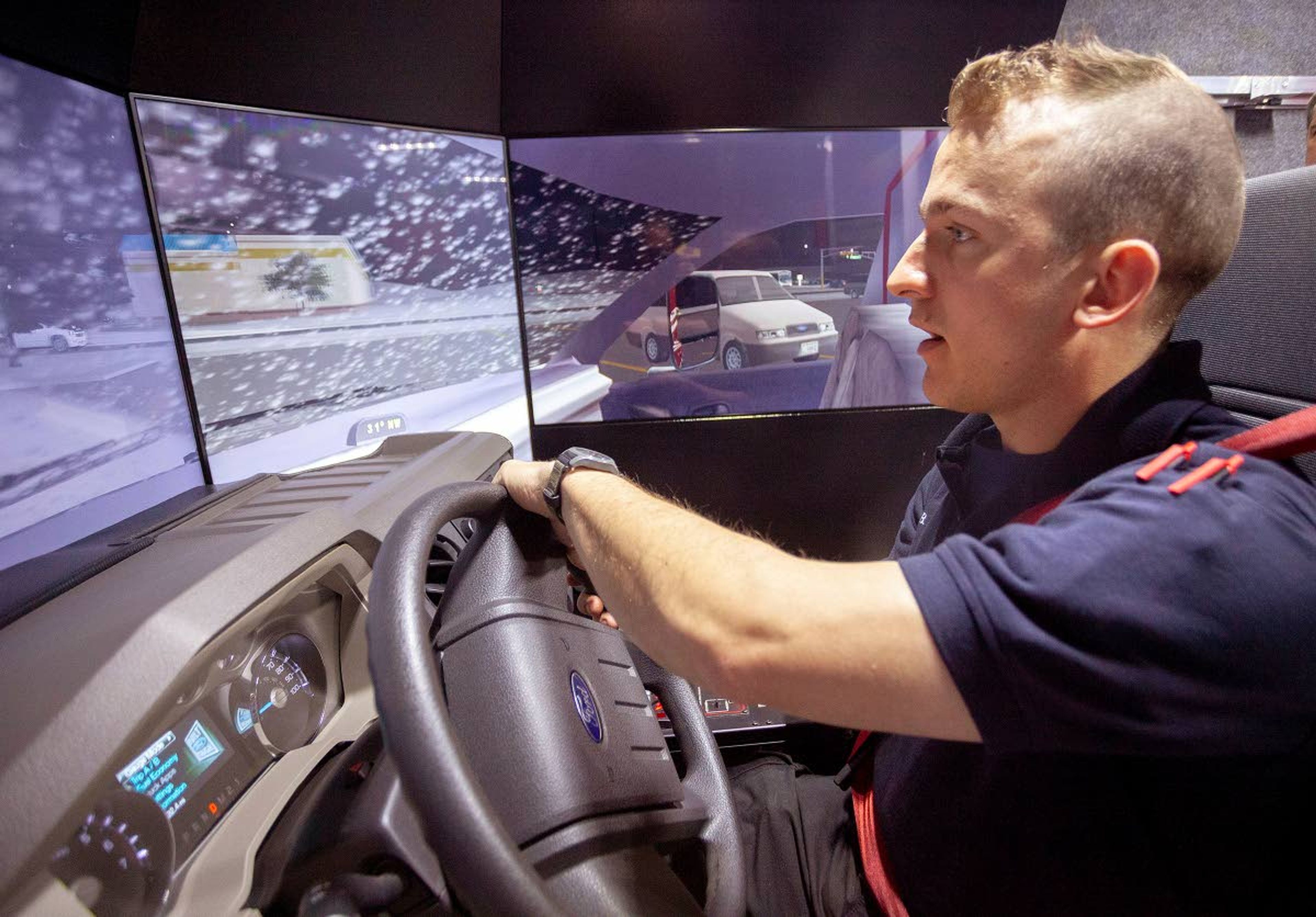 Resident firefighter Ben Bechard drives an ambulance through a snow storm in a driving simulator Monday outside Fire Station 2 in Moscow.