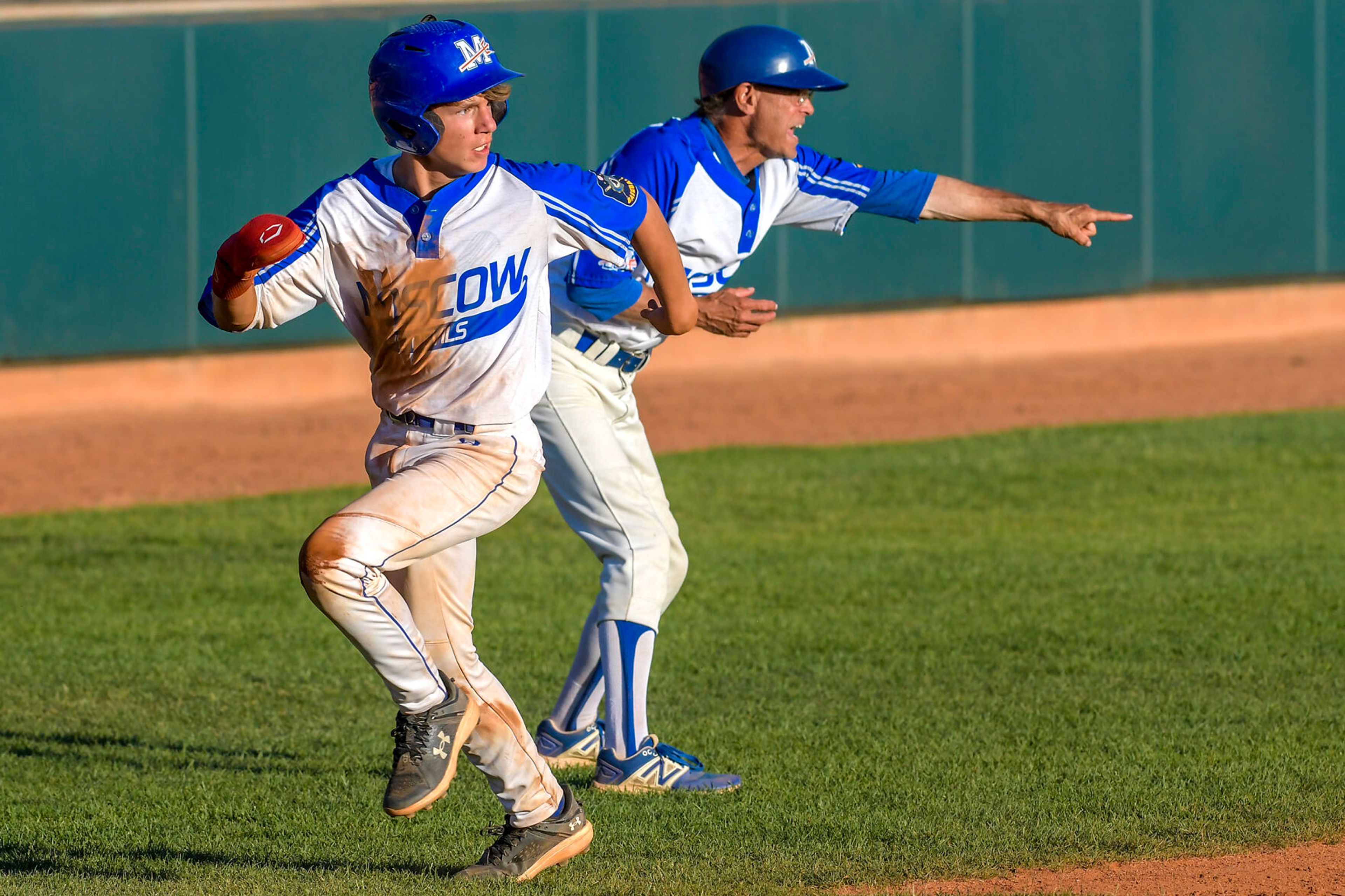 The Moscow Blue Devils' Benson Godfrey runs for home to score against the Lewis-Clark Cubs in a game of the Clancy Ellis Tournament on Saturday at Harris Field in Lewiston.