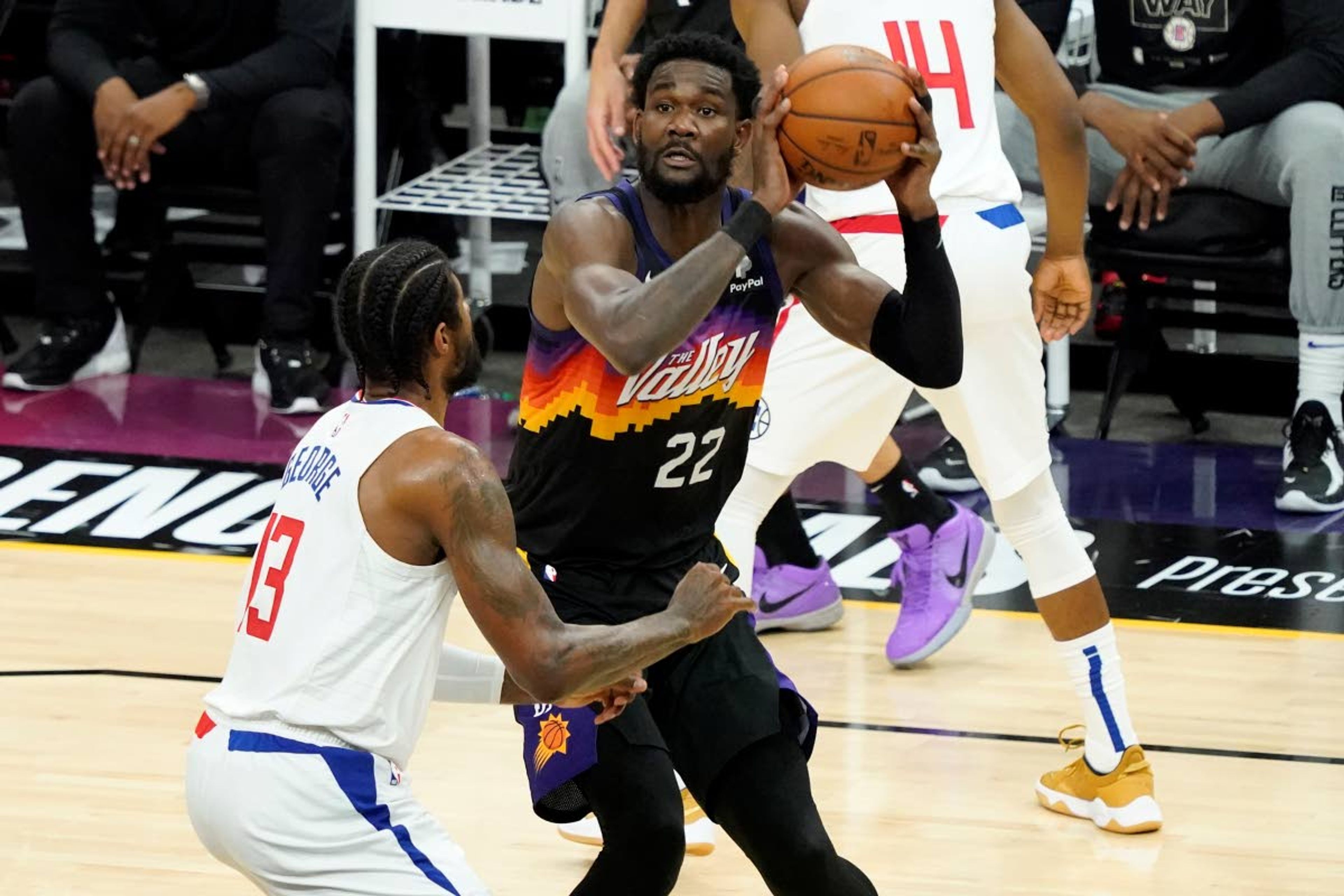 Phoenix Suns center Deandre Ayton (22) shoots as Los Angeles Clippers guard Paul George (13) defends during the first half of game 5 of the NBA basketball Western Conference Finals, Monday, June 28, 2021, in Phoenix. (AP Photo/Matt York)