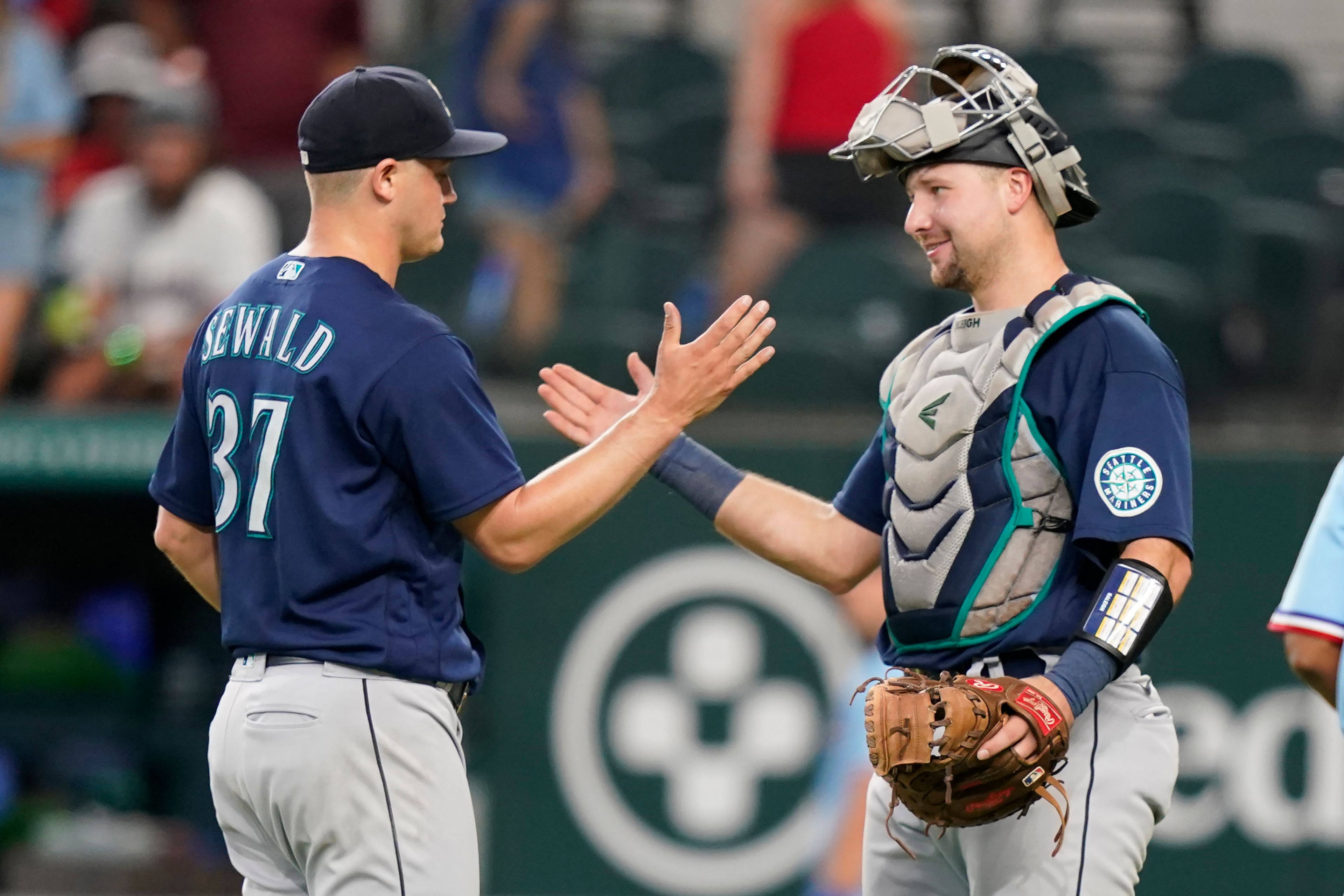 Associated PressMariners closer Paul Sewald (37) is congratulated by teammate catcher Cal Raleigh after the final out of a baseball game against the Rangers on July 17 in Arlington, Texas.