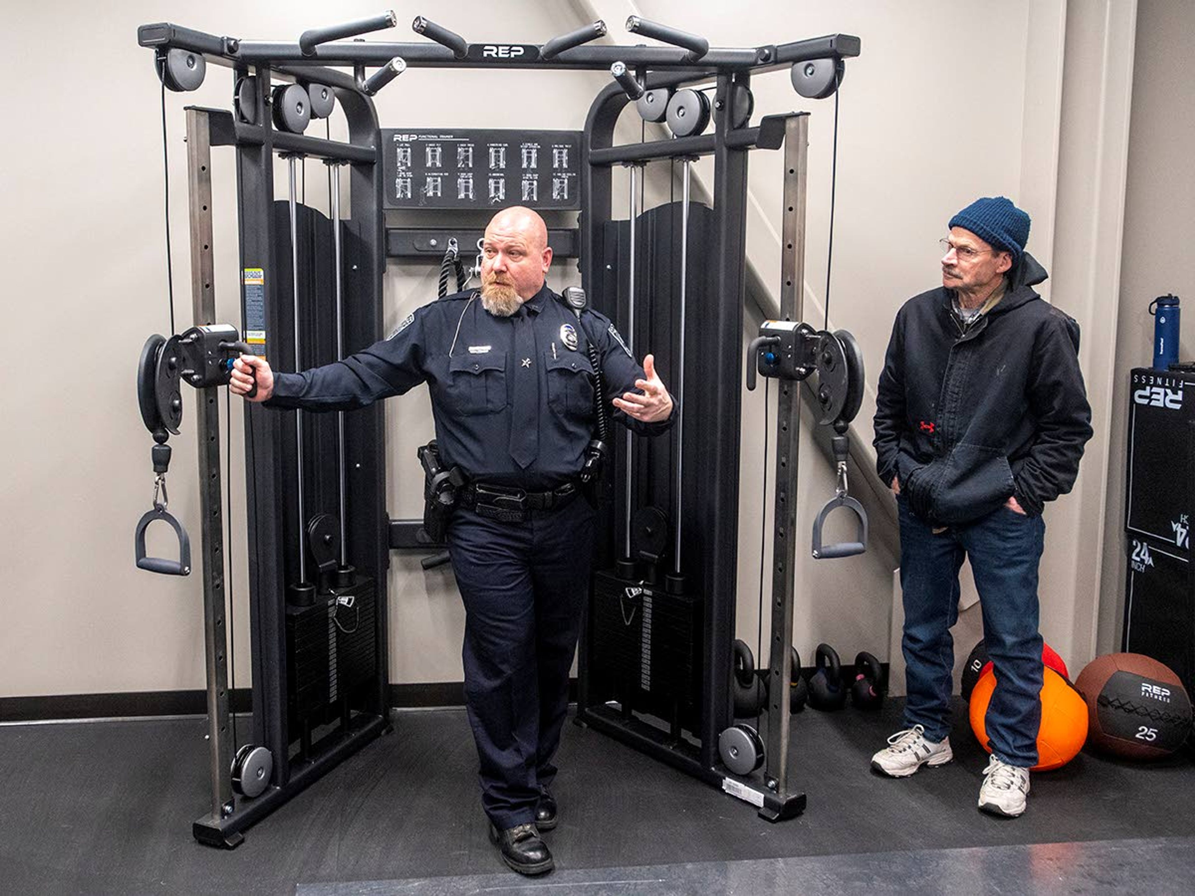 Sgt. Dustin Blaker gives a tour of the new weight room, while emphasizing the importance of staying active and maintaining good health for officers.