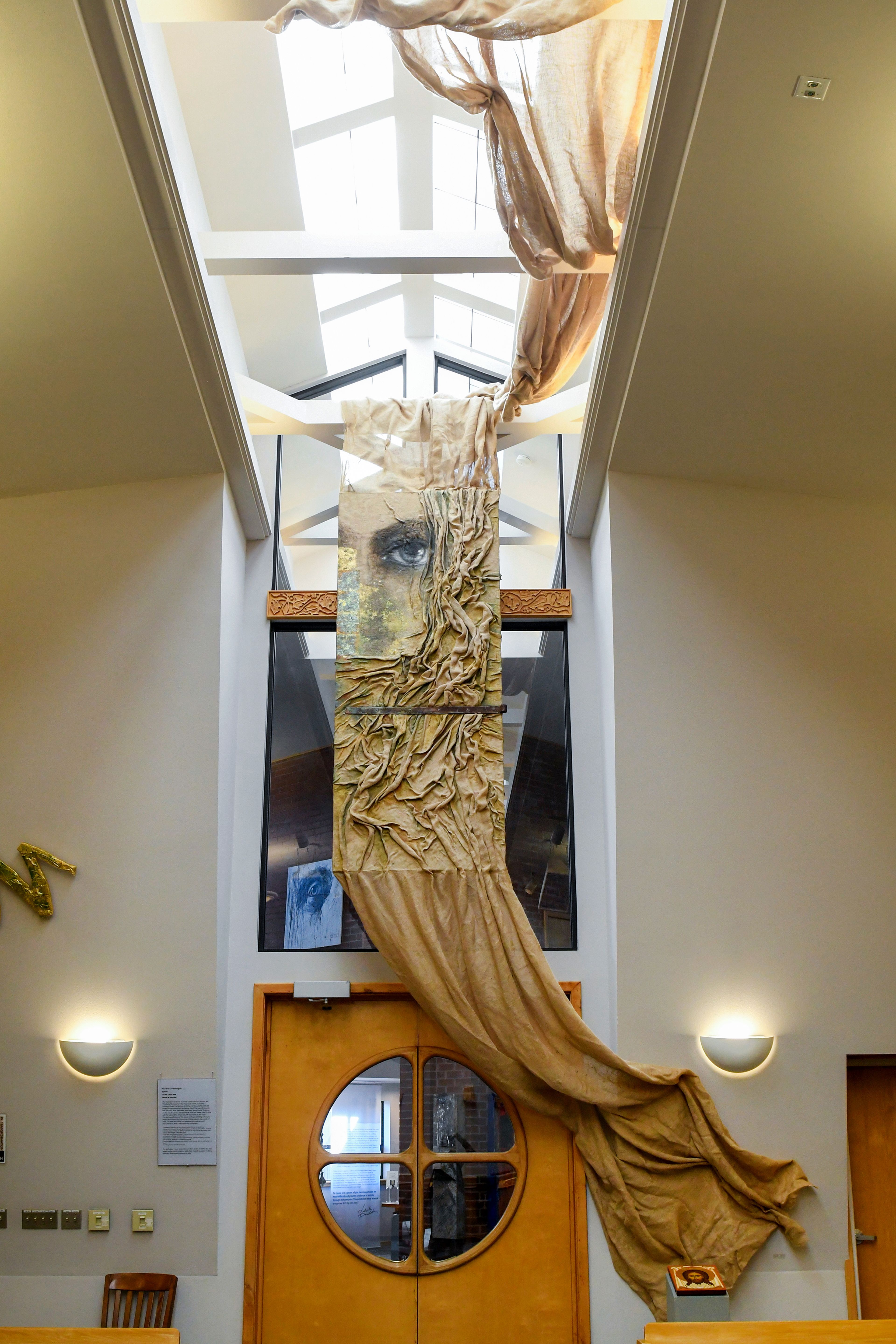 Pieces from Ludmila Pawlowskas traveling exhibit, Icons in Transformation, are hung Thursday in the sanctuary of St. James Episcopal Church in Pullman.