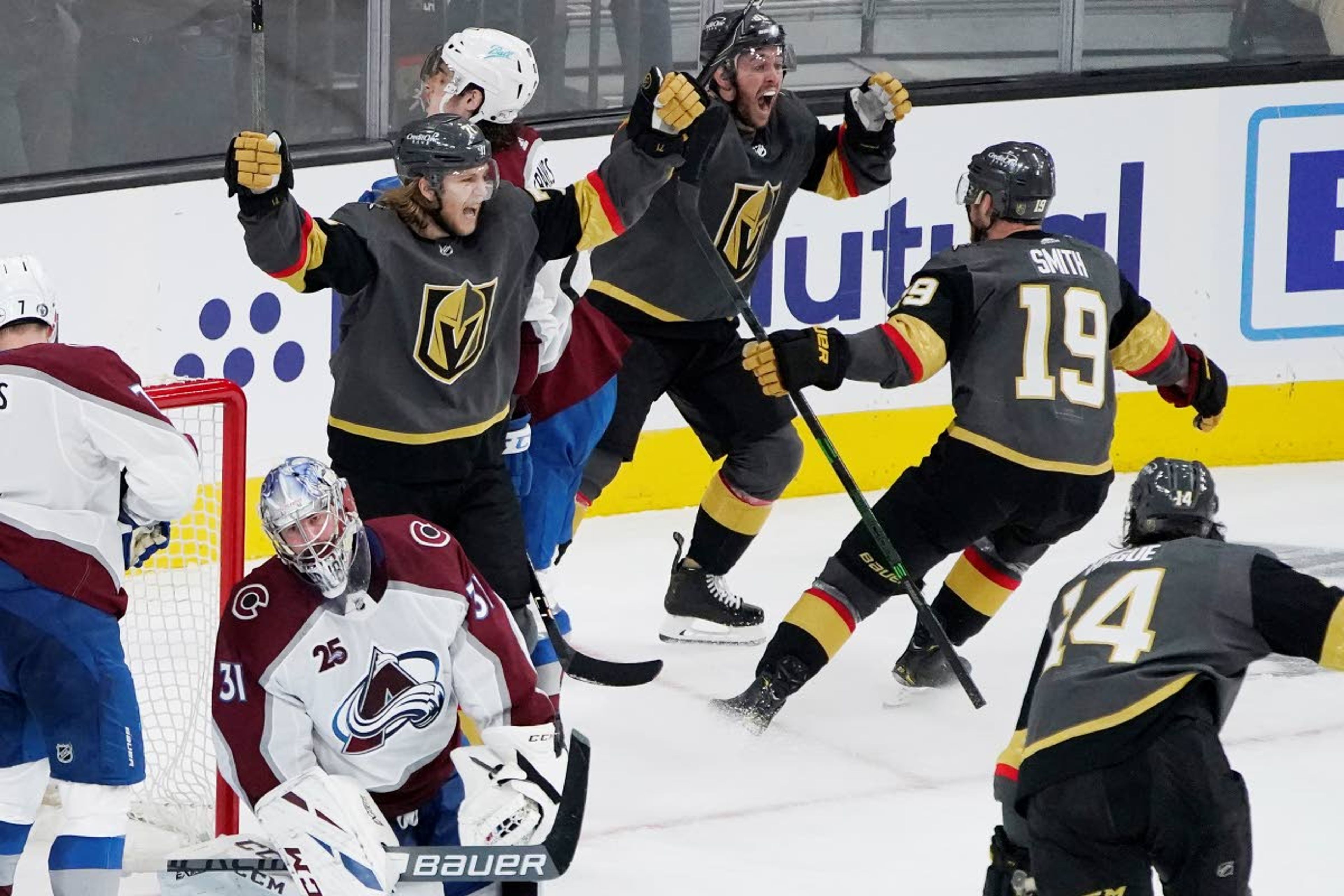 Vegas Golden Knights celebrate after center Jonathan Marchessault, top, scored against the Colorado Avalanche during the third period in Game 3 of an NHL hockey Stanley Cup second-round playoff series Friday, June 4, 2021, in Las Vegas. (AP Photo/John Locher)