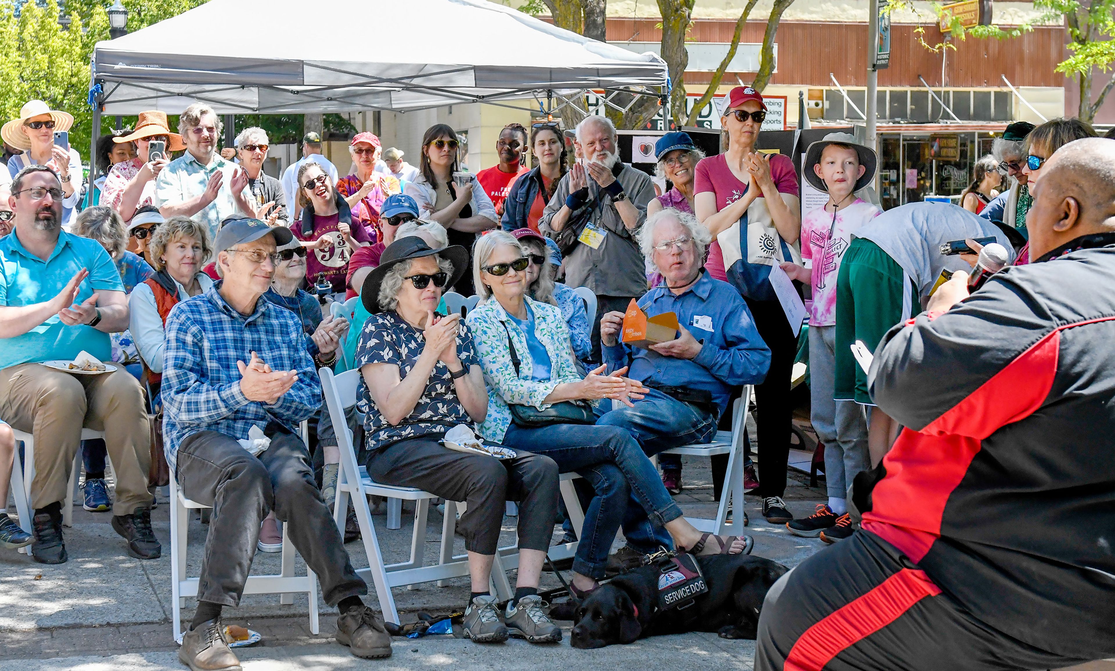 Community members applaud from Friendship Square as James Montgomery Bledsoe, right, speaks at a Juneteenth celebration on Wednesday in Moscow.