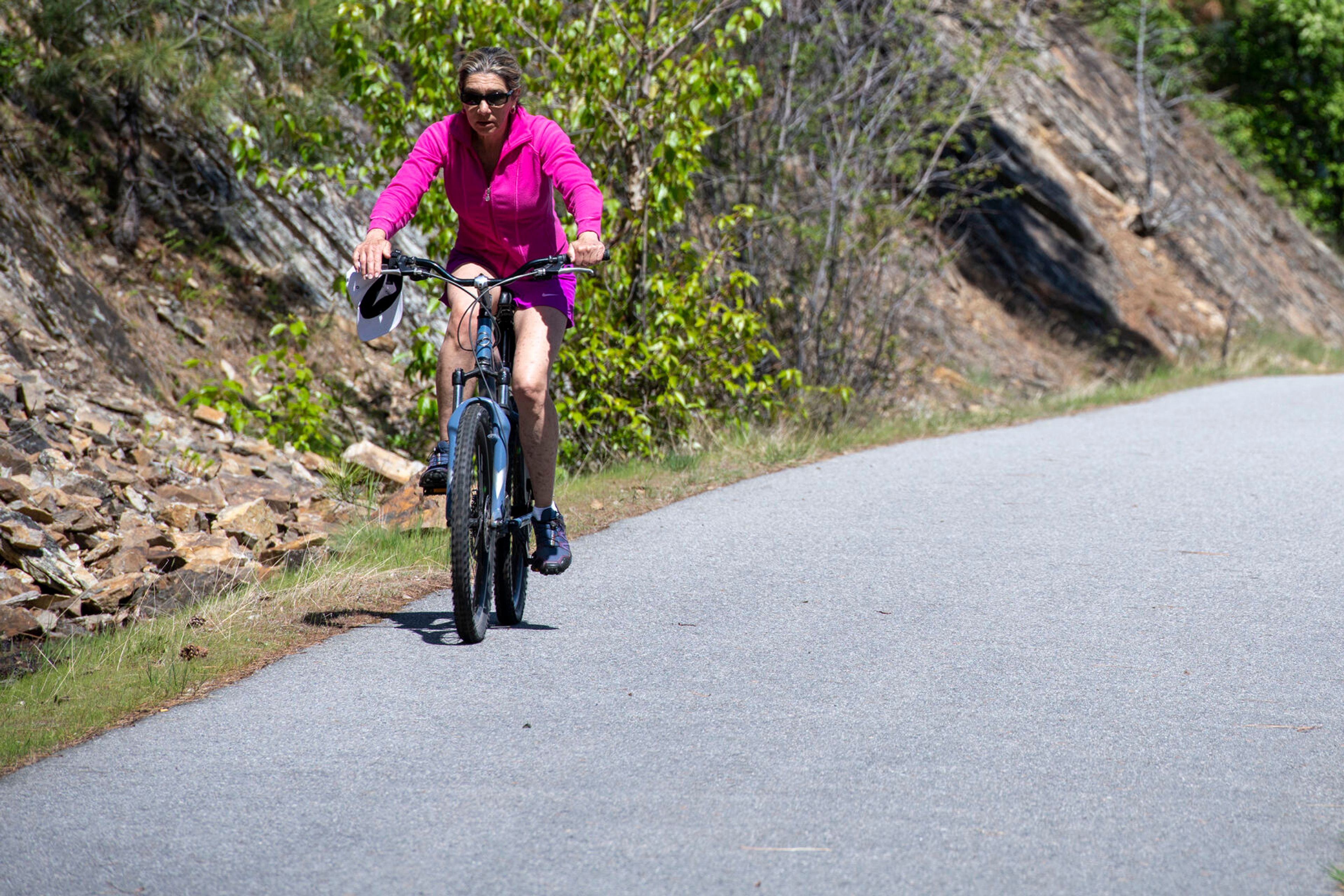 A cyclist rides on the Trail of the Coeur d’Alene.