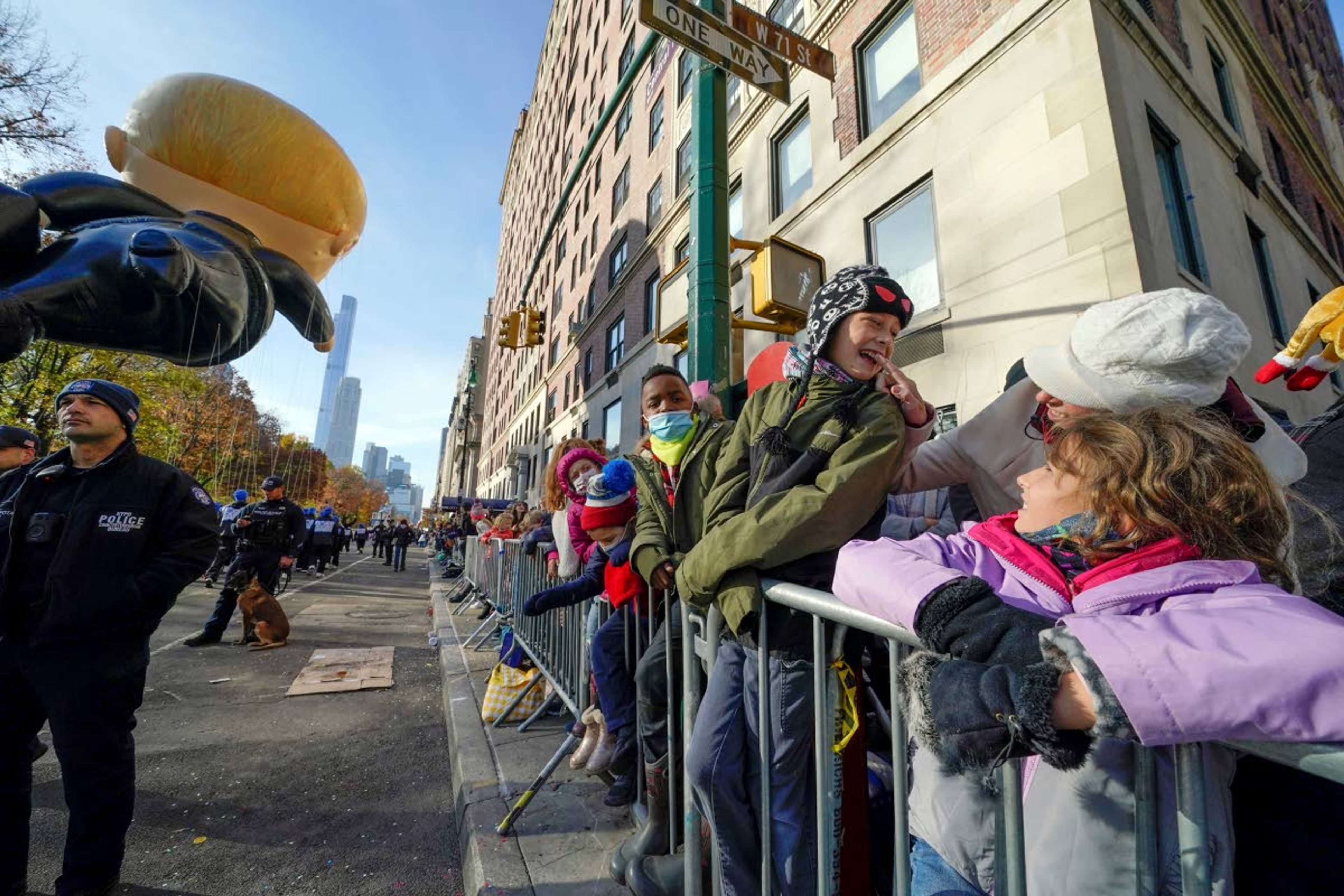 Associated PressPeople watch as the Macy’s Thanksgiving Day Parade passes by.