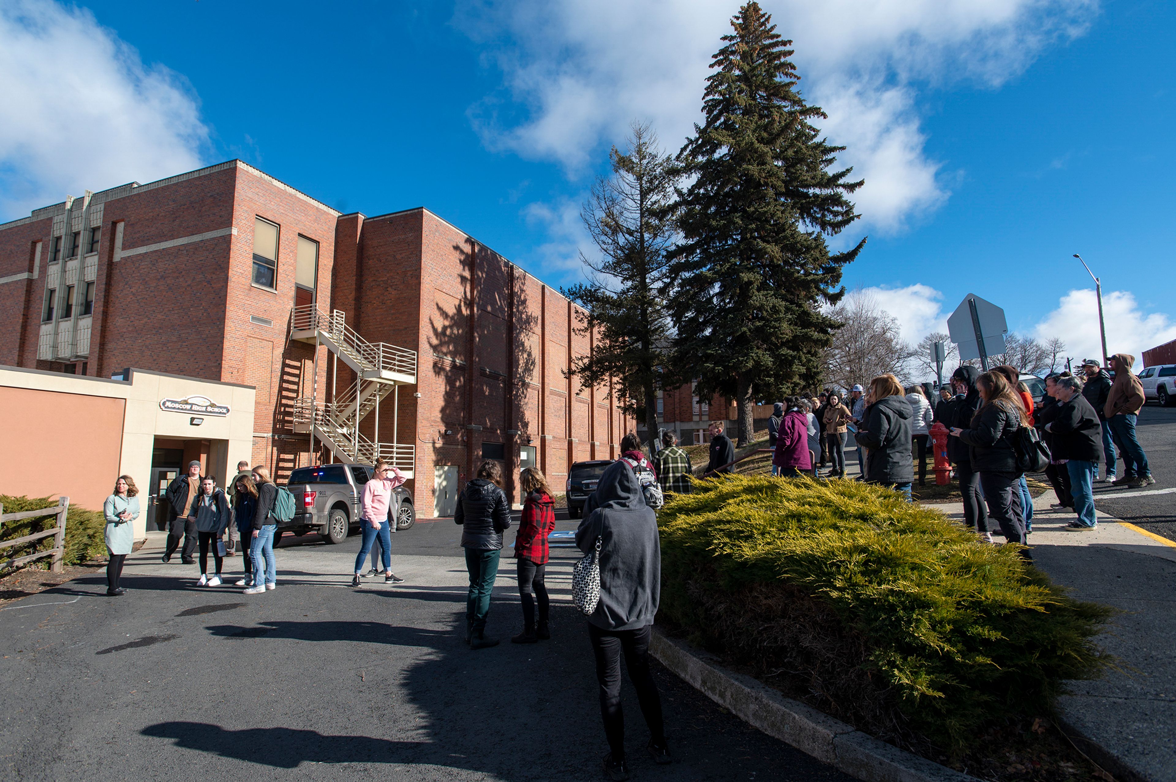 Parents wait on the Fifth Street sidewalk as their children are released in small groups from Moscow Highs School on Wednesday following the investigation of an active threat on campus.