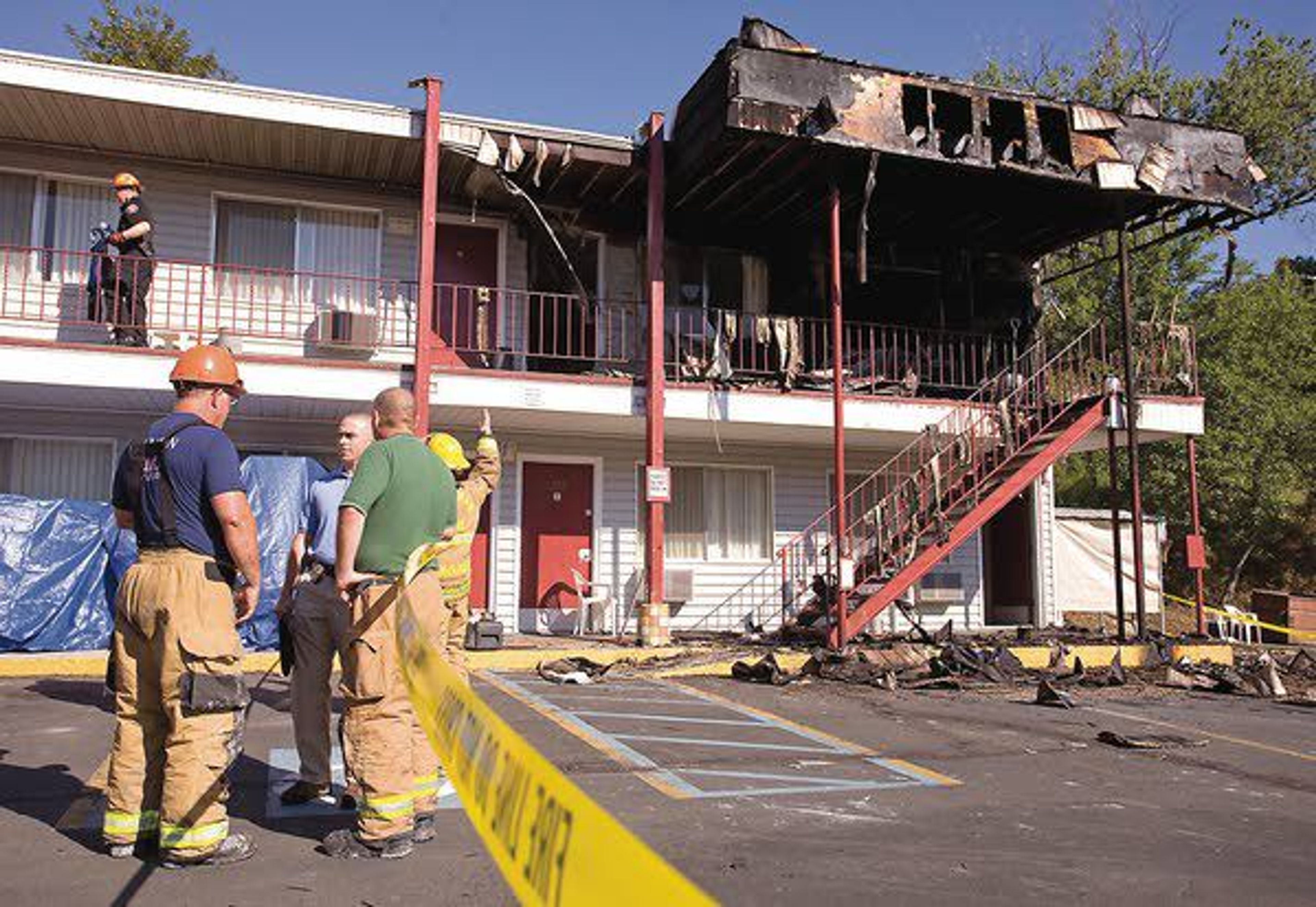 Investigators from the Pullman Fire Department and Washington State University Police Department work to determine the cause of a fire at the American Travel Inn on Tuesday on south Grand Avenue in Pullman.