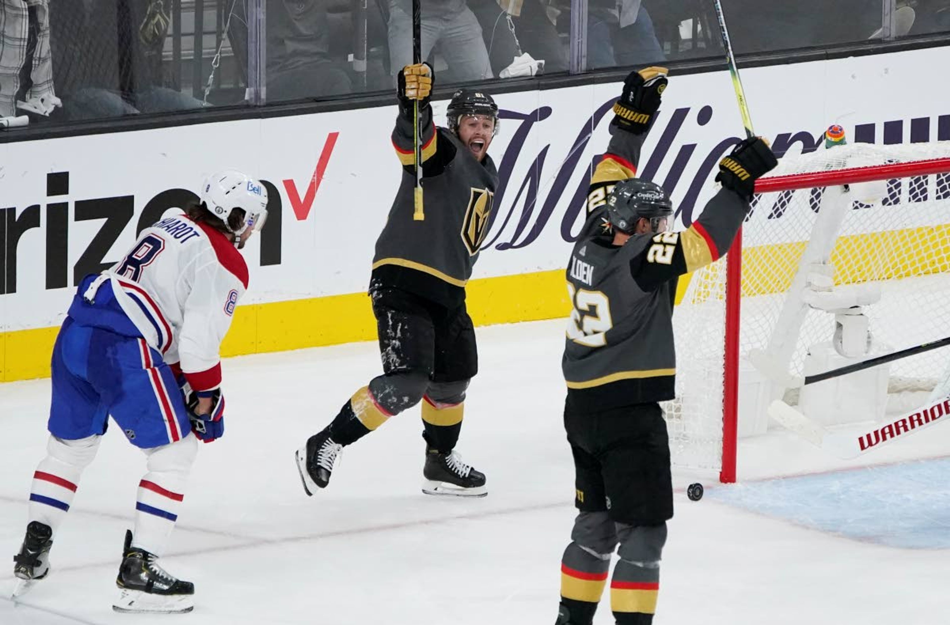 Vegas Golden Knights center Jonathan Marchessault, center, celebrates after Vegas Golden Knights defenseman Nick Holden, right, scored against the Montreal Canadiens during the third period in Game 1 of an NHL hockey Stanley Cup semifinal playoff series Monday, June 14, 2021, in Las Vegas. (AP Photo/John Locher)