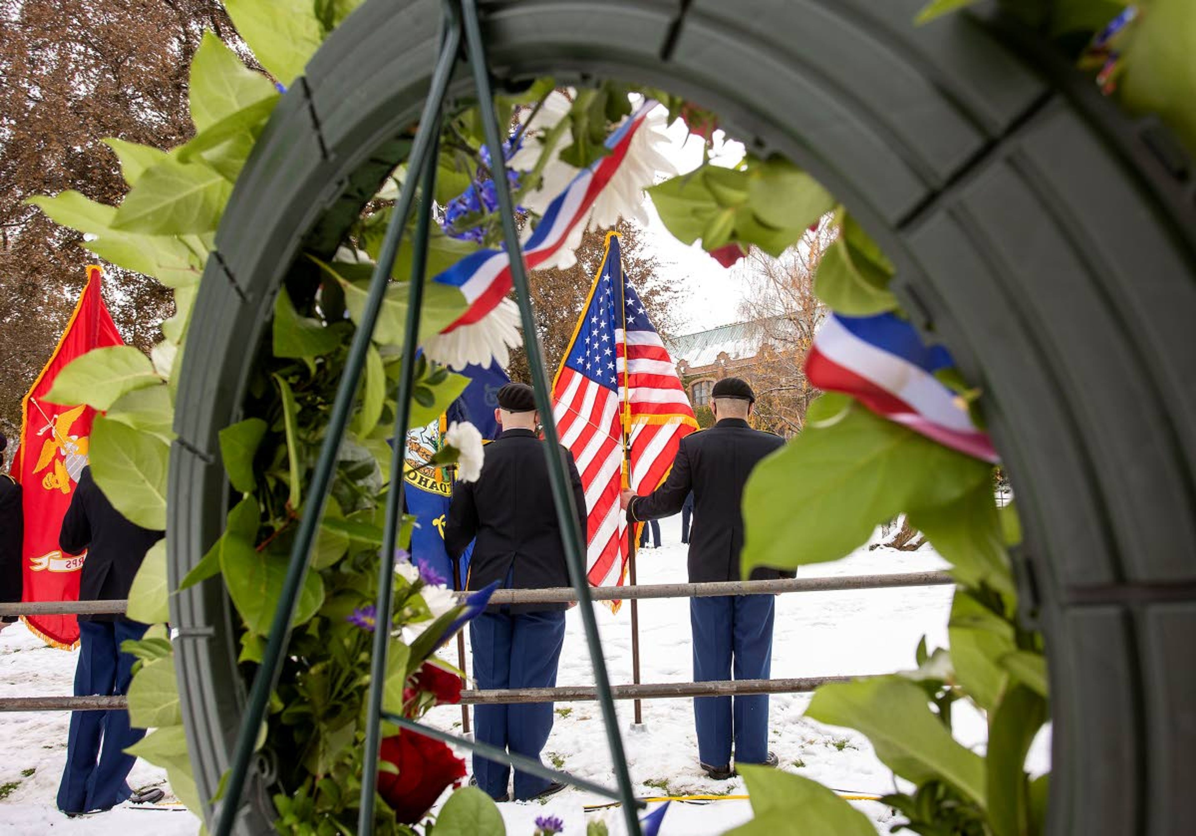 A color guard is is seen through a memorial wreath during a University of Idaho Veterans Day ceremony on Wednesday in Moscow.