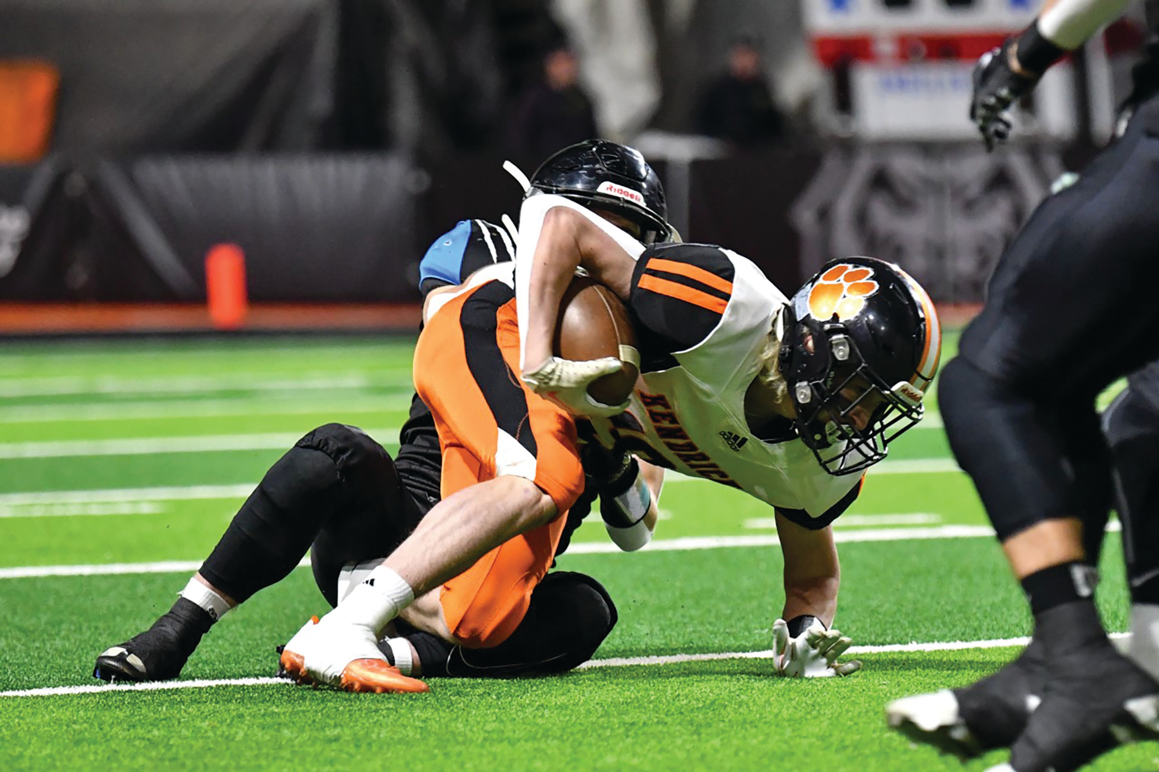 Scott Kirtley/For The Tribune Kendrick sophomore running Sawyer Hewett breaks the tackle of a Dietrich player and eventually scores a touchdown during the Idaho Class 1A Division II football state championship game at Holt Arena in Pocatello.