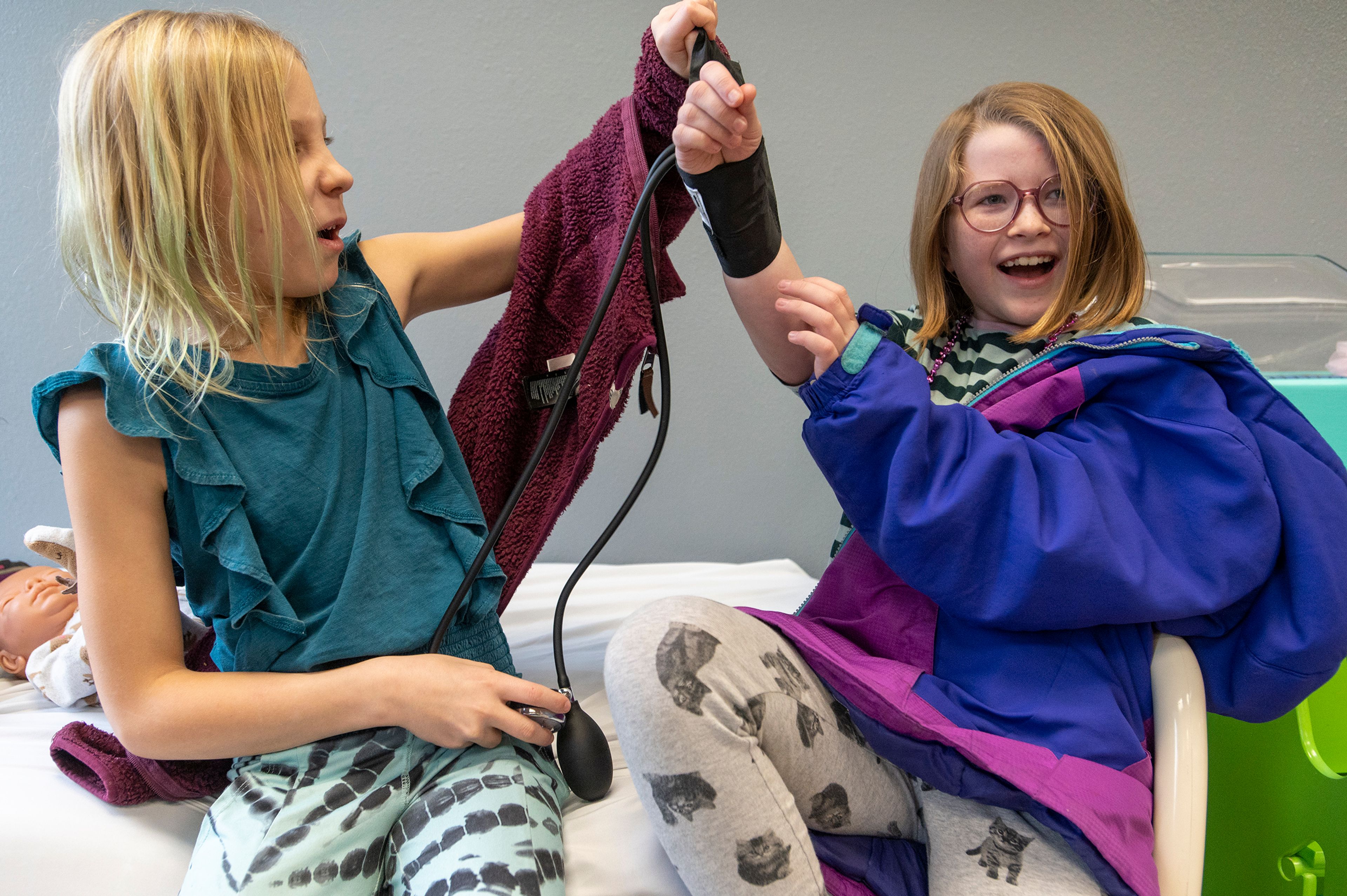 Lily, left, uses a blood pressure cuff on her classmate, Marken, while touring the “Everybody Healthy” exhibit at the Palouse Discovery Science Center in Pullman on Thursday.