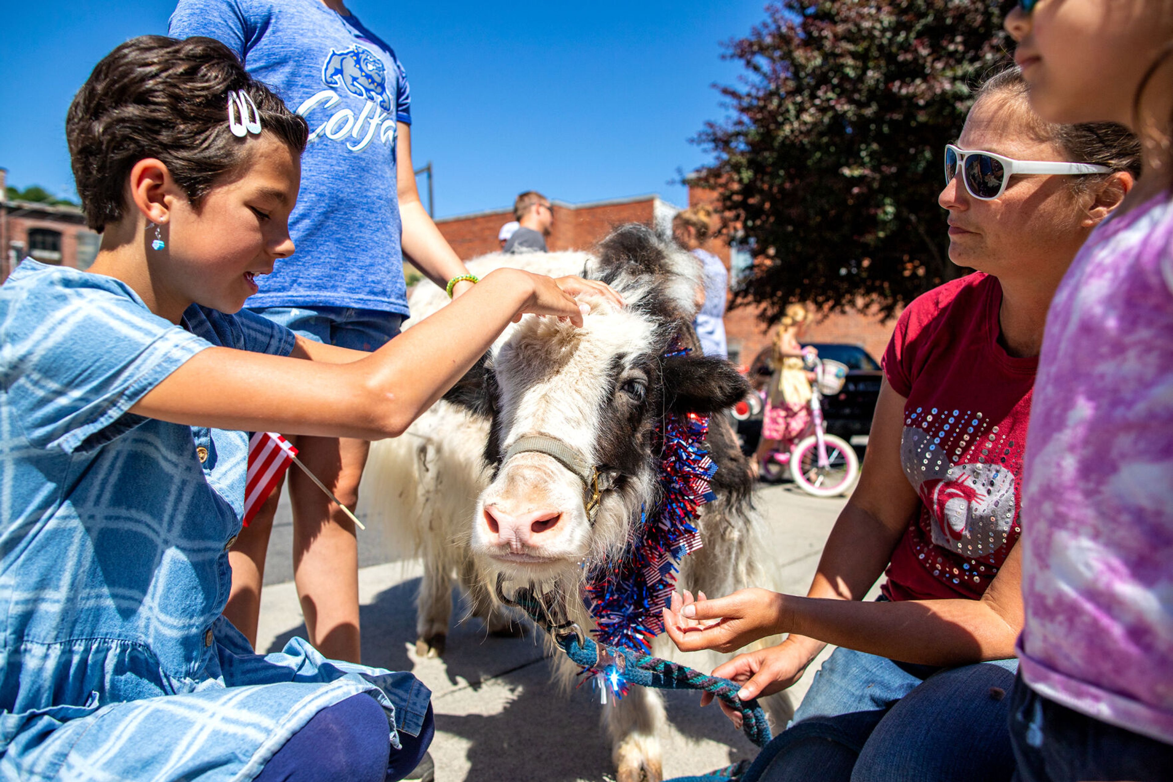 Kids stop to pet Jack the Yak on Saturday during the city of Colfax’s 150th birthday celebration.