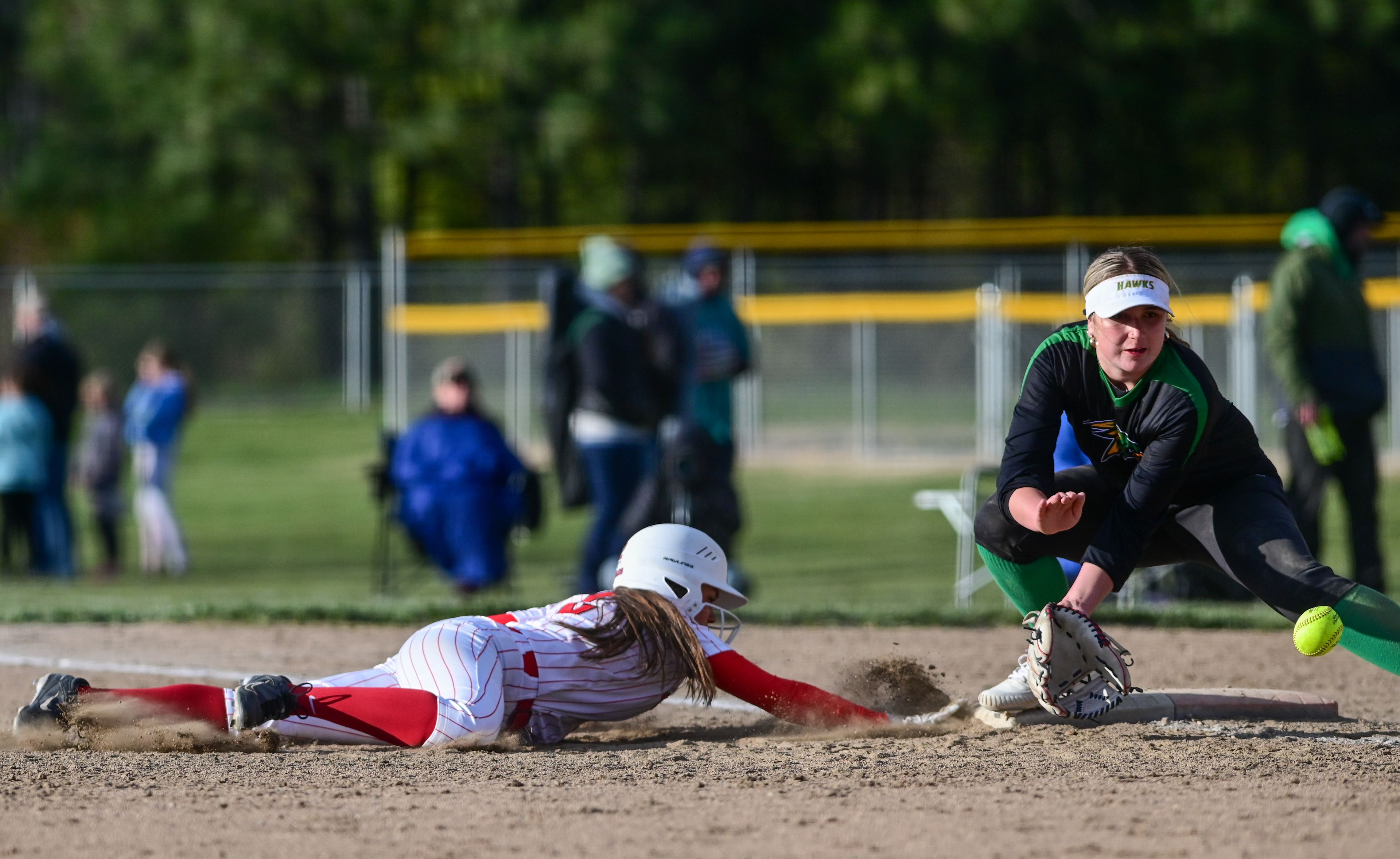 Moscow’s Sadie Newlan (2), left, slides to tag up just before a catch by Lakeland’s first baseman in Moscow on Tuesday.