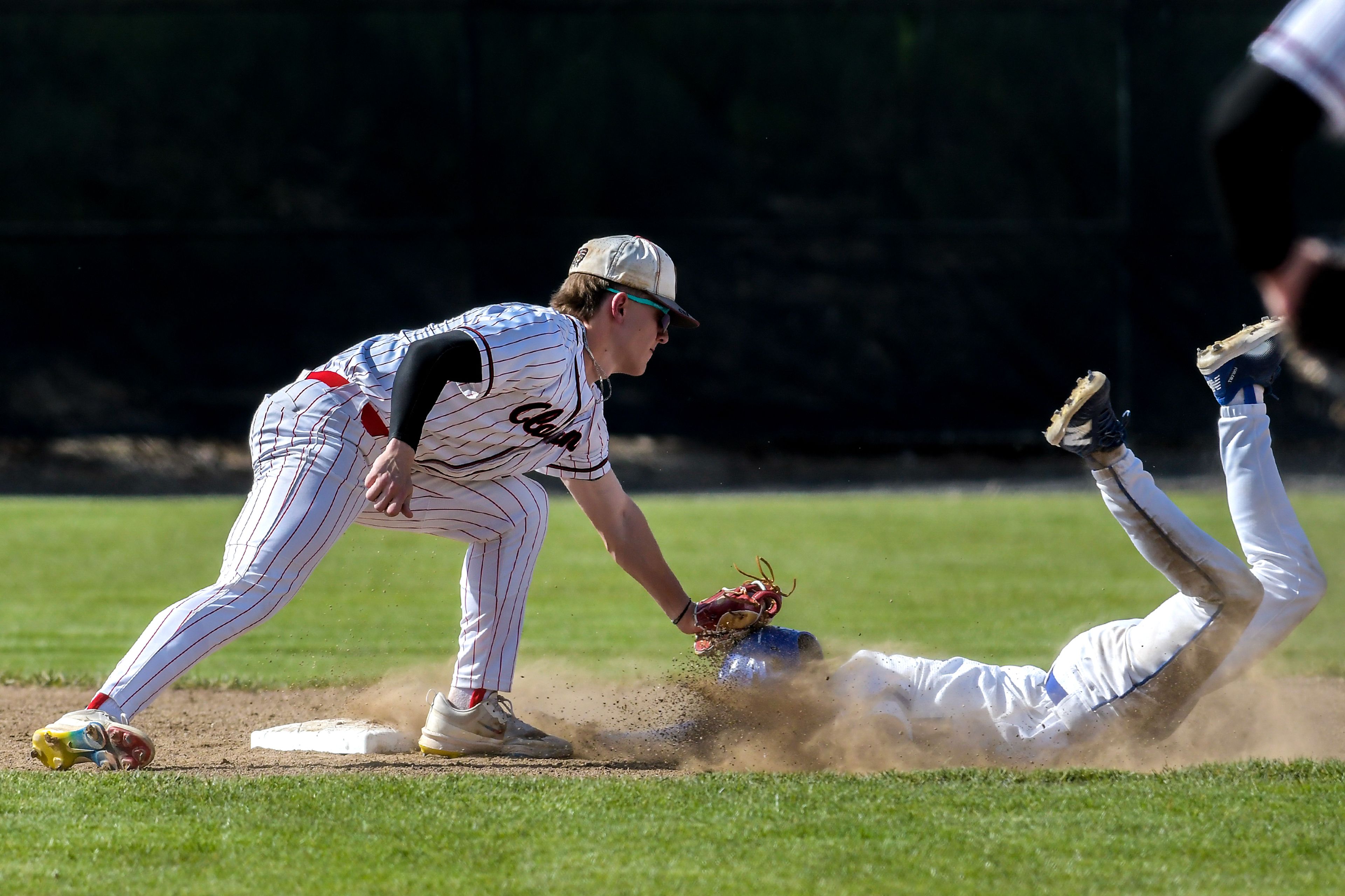 Clarkston shortstop Hayden Line tags out Pullman’s Brayden Randall in an inning of a semifinal game of the District tournament Thursday in Pullman.