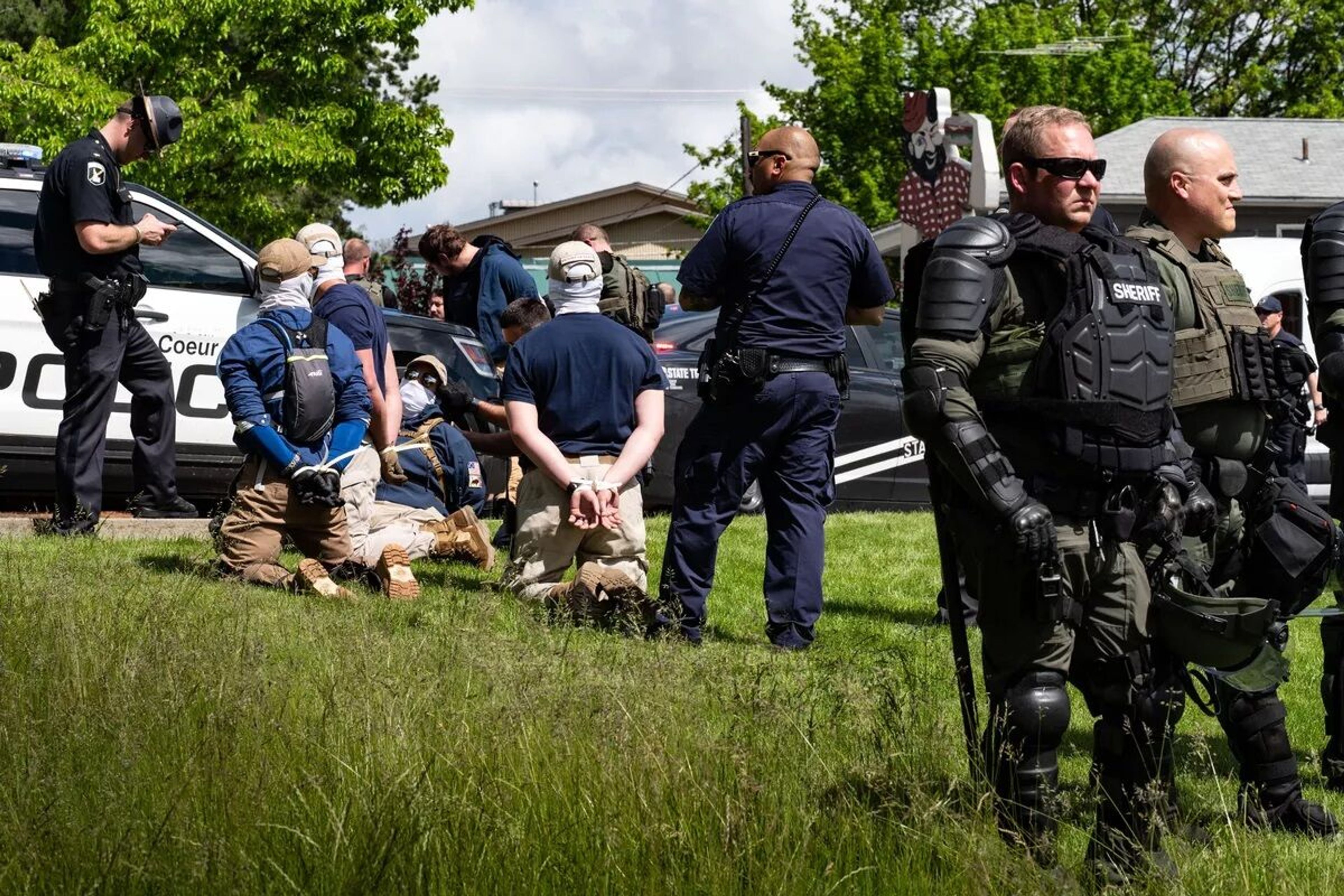 A large group of men with their faces concealed were removed from the back of a U-Haul rental truck and arrested Saturday after a traffic stop by multiple police agencies on Northwest Boulevard in Coeur d’Alene. 