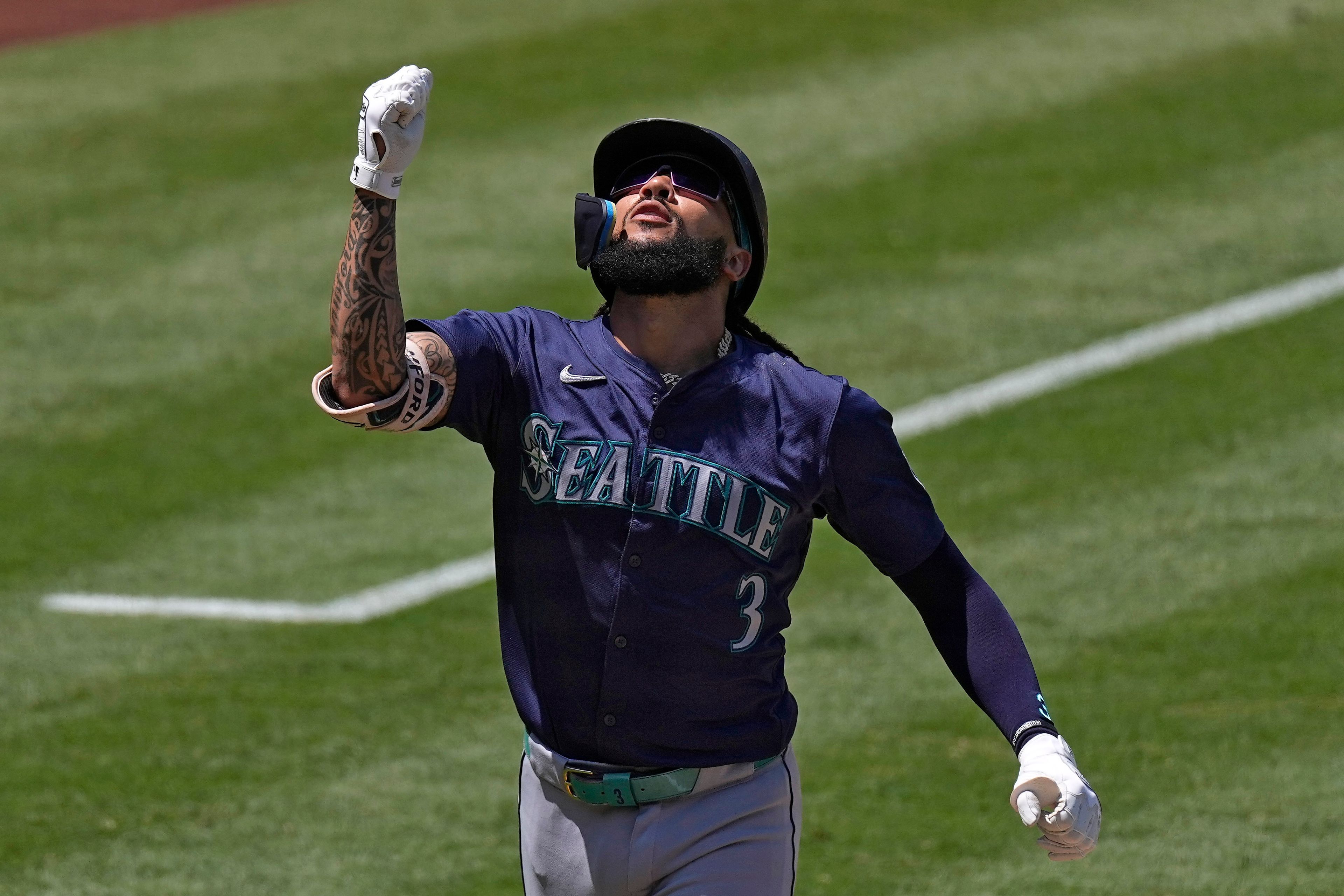 Seattle Mariners' J.P. Crawford gestures after hitting a solo home run during the seventh inning of a baseball game against the Los Angeles Angels Sunday, July 14, 2024, in Anaheim, Calif. (AP Photo/Mark J. Terrill)