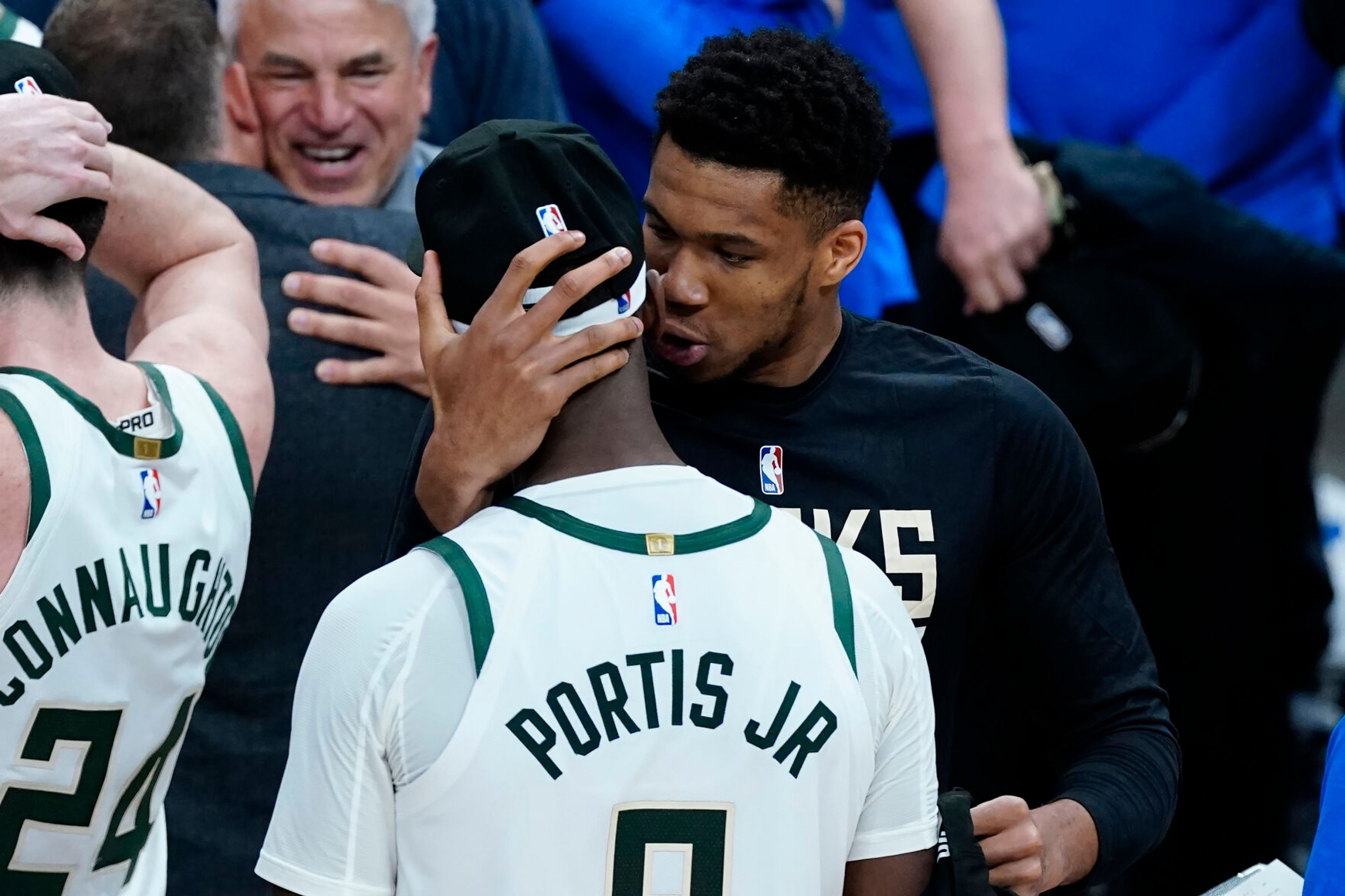 Milwaukee Bucks forward Giannis Antetokounmpo embraces Bobby Portis (9) after the Bucks defeated the Atlanta Hawks in Game 6 of the Eastern Conference finals in the NBA basketball playoffs, advancing to the NBA Finals, Saturday, July 3, 2021, in Atlanta. (AP Photo/John Bazemore)