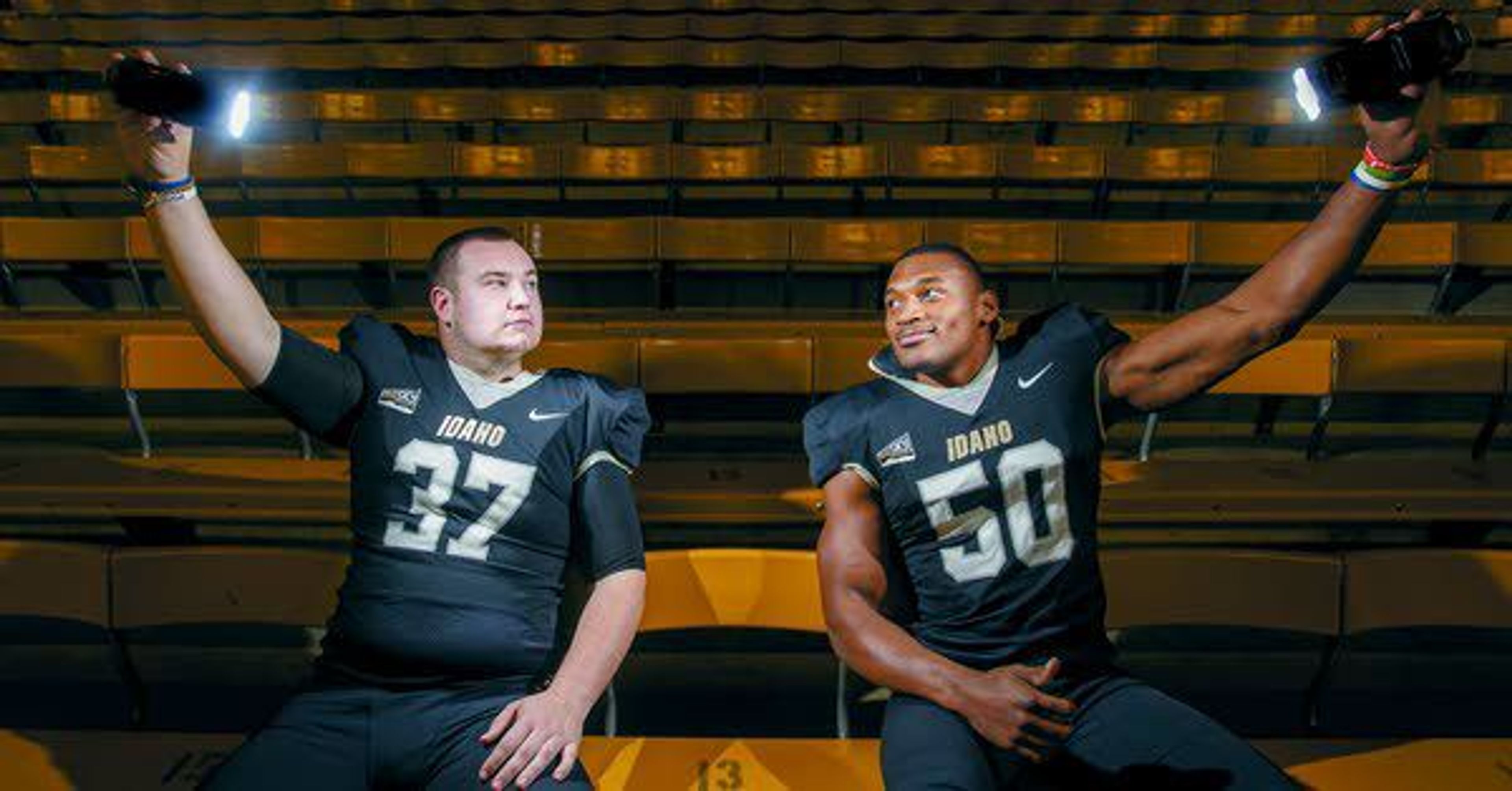 Idaho long snapper Alex Boatman, left, and linebacker Ed Hall help with the lighting as they pose for a portrait in the Kibbie Dome on Wednesday in Moscow. The two Vandal redshirt seniors are teammates on the field, roommates off the field and potential business partners after they graduate.